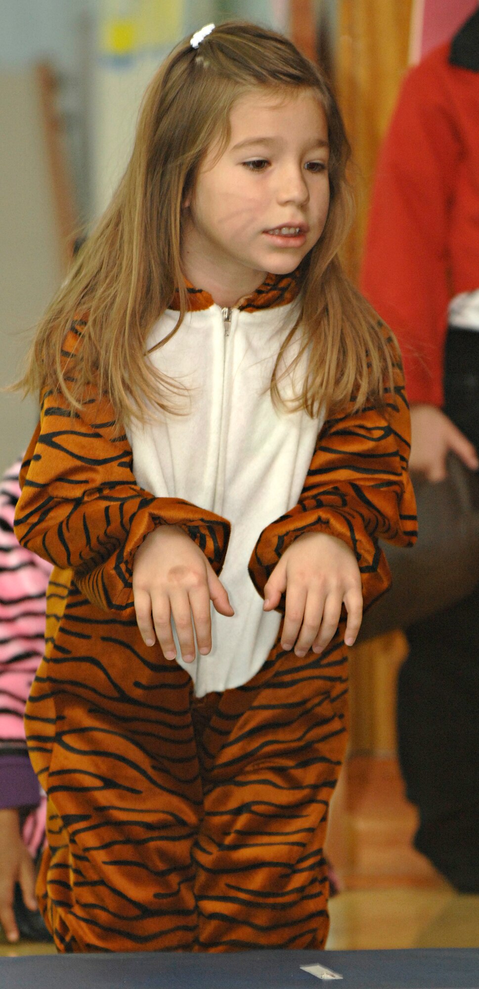 Fenix Camarillo, daughter of Staff Sgt. Gabriel Camarillo, 728th Air Mobility Squadron, acts as a tiger during the kindergarten circus at the Incirlik Unit School, Friday, March 27, 2009. The children helped design the set, props and costumes, as well as writing the script for the circus they put on for their parents. The whole experience incorporated learning about animals along with math and writing, said Harry Atkinson, IUS kindergarten teacher. (U.S. Air Force photo/Senior Airman Benjamin Wilson, 39th Air Base Wing Public Affairs)