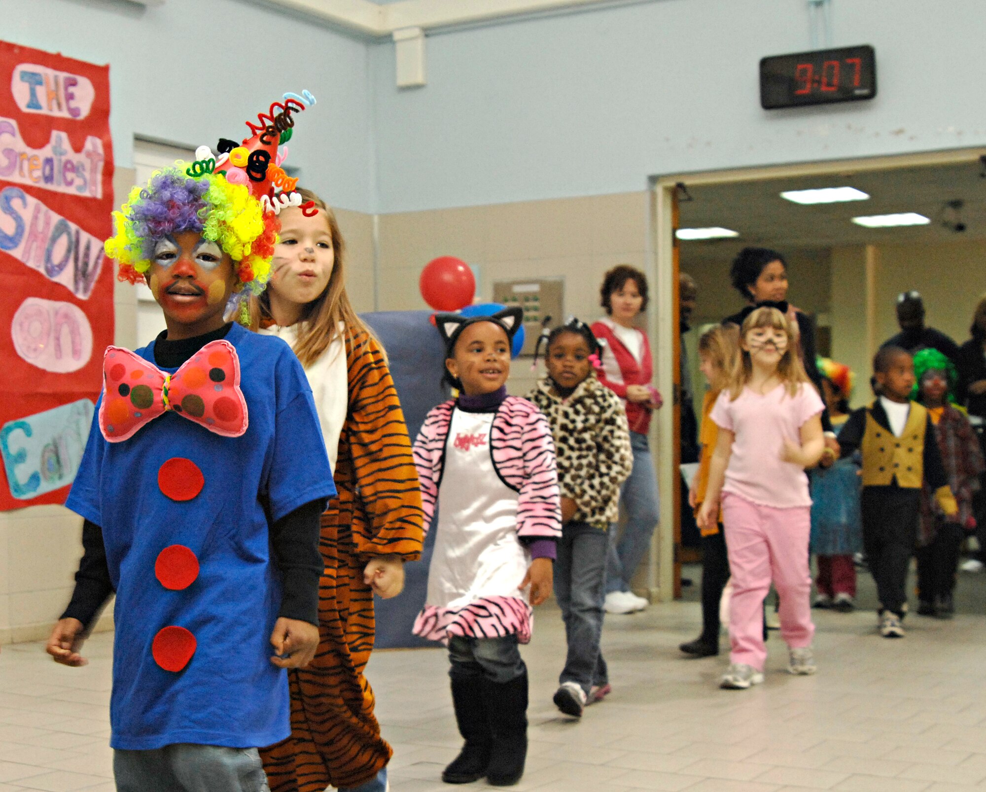 Children march into the Incirlik Unit School cafeteria before performing in the kindergarten circus, Friday, March 27, 2009. The children helped design the set, props and costumes, as well as writing the script for the circus they put on for their parents. The whole experience incorporated learning about animals along with math and writing, said Harry Atkinson, IUS kindergarten teacher. (U.S. Air Force photo/Senior Airman Benjamin Wilson, 39th Air Base Wing Public Affairs)
