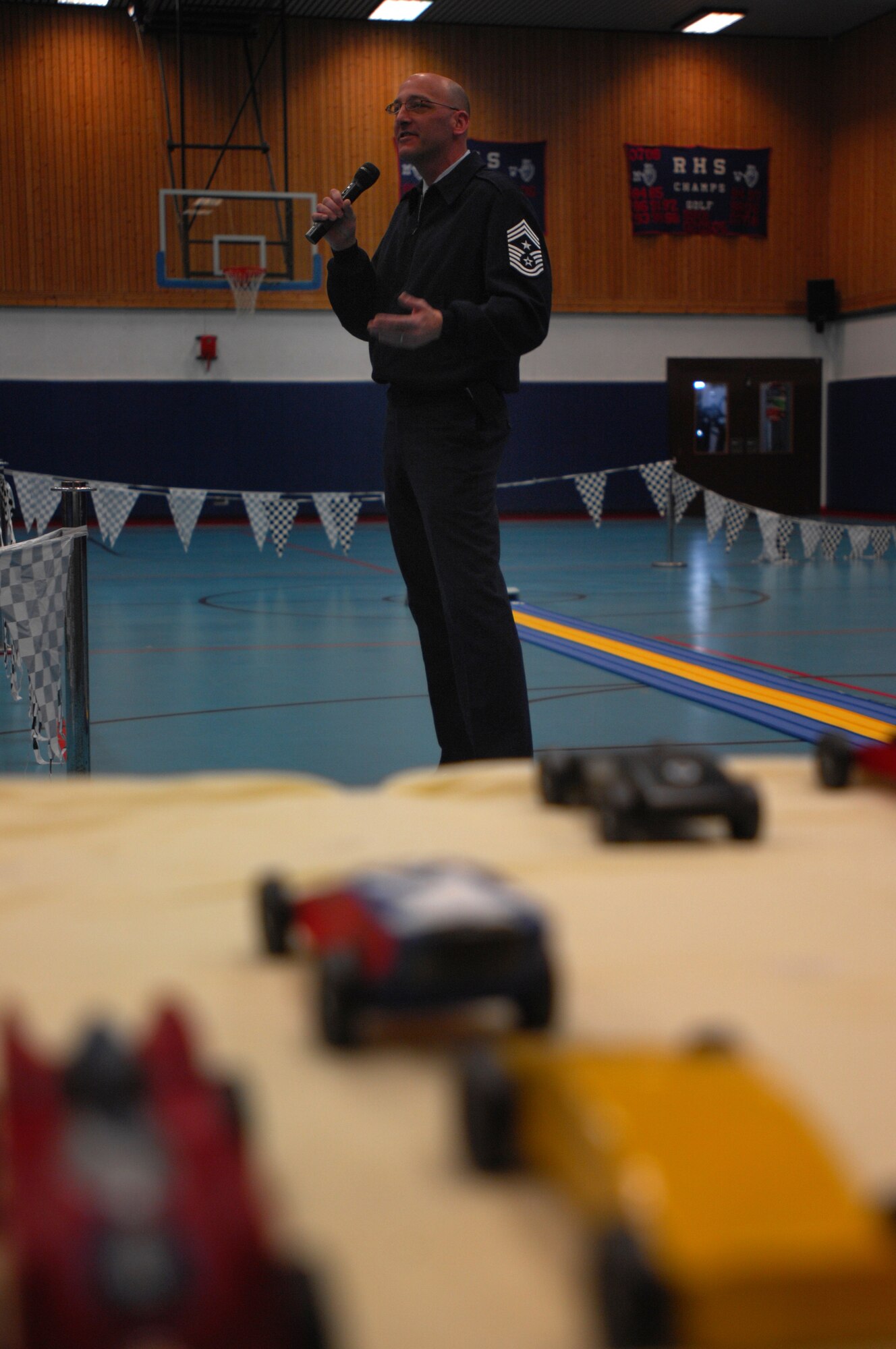435th Command Chief Master Sgt. Mitch  Stippel, says a few words during the opening ceremonies of the Cub Scout District Level Pinewood Derby contest, March 19, 2009 at the Ramstein High School gym. The pinewood derby encourages scouts to learn and improve on their craftsmanship plus practice good sportsmanship. (U.S. Air Force photo by Airman 1st Class Kenny Holston)