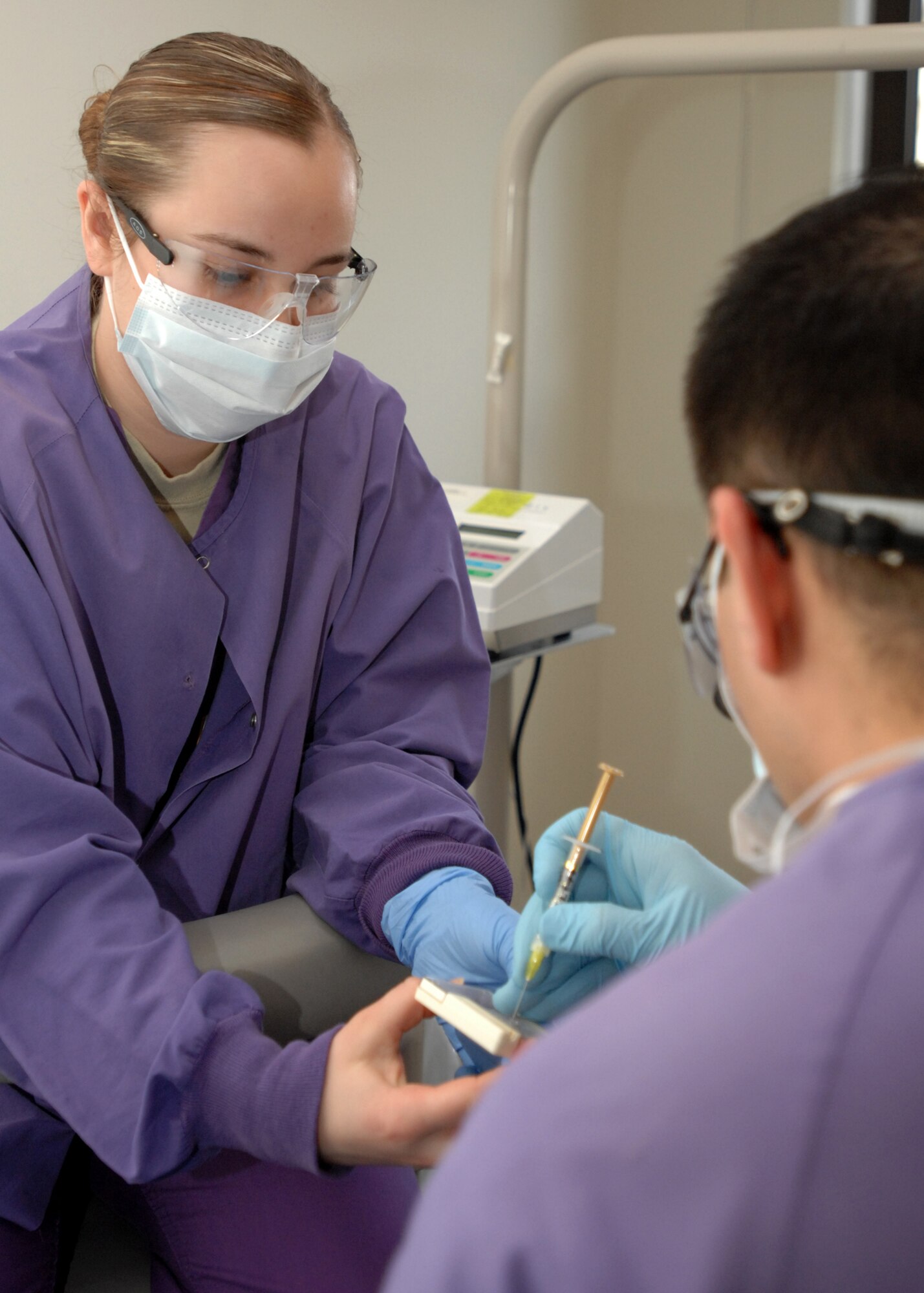 SPANGDAHLEM AIR BASE, Germany -- Airman 1st Class Danielle Kinder, 52nd Dental Squadron, assists a dentist with a filling March 27, 2009. She is a dental assistant from Findlay, Ohio.  Airman Kinder is the 52nd Fighter Wing's Top Saber Performer for the week of April 3-9. (U.S. Air Force photo by Senior Airman Jenifer H. Calhoun)