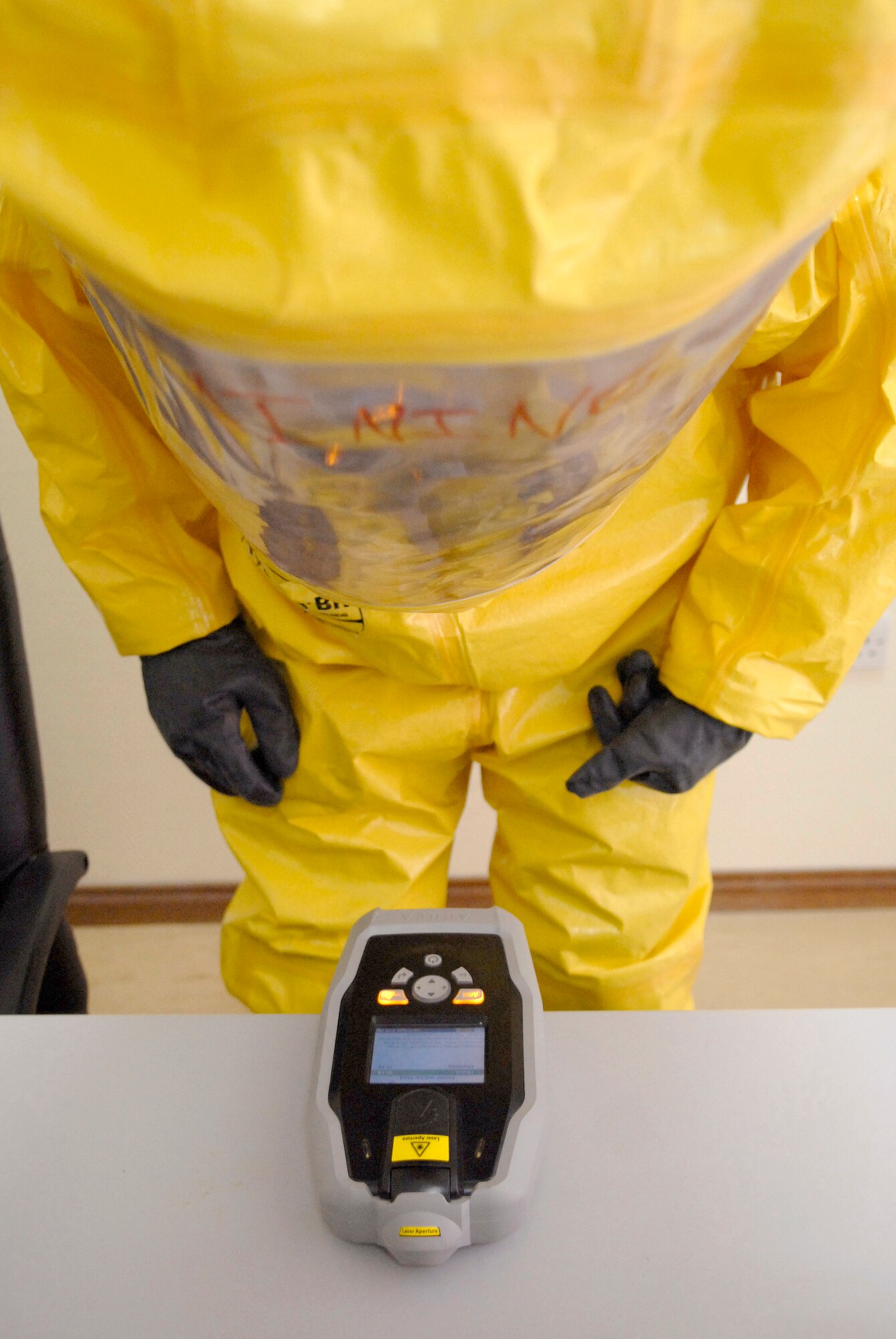 Staff Sgt. Trevor Fettig, a 379th Civil Engineer Squadron Emergency Management Journeyman, analyzes a liquid sample for contamination which was discovered during a unit exercise, Mar. 27, 2009, at an undisclosed location in Southwest Asia.  Sergeant Fettig is labeled the 'dirty man' while handling the contaminated items during the check to prevent cross contamination with other team members.  Sergeant Fettig hails from Lompoc, Calif. and is deployed from Travis Air Force Base, Calif. in support of Operations Iraqi and Enduring Freedom and Combined Joint Task Force - Horn of Africa.  (U.S. Air Force photo/Senior Airman Andrew Satran/released)