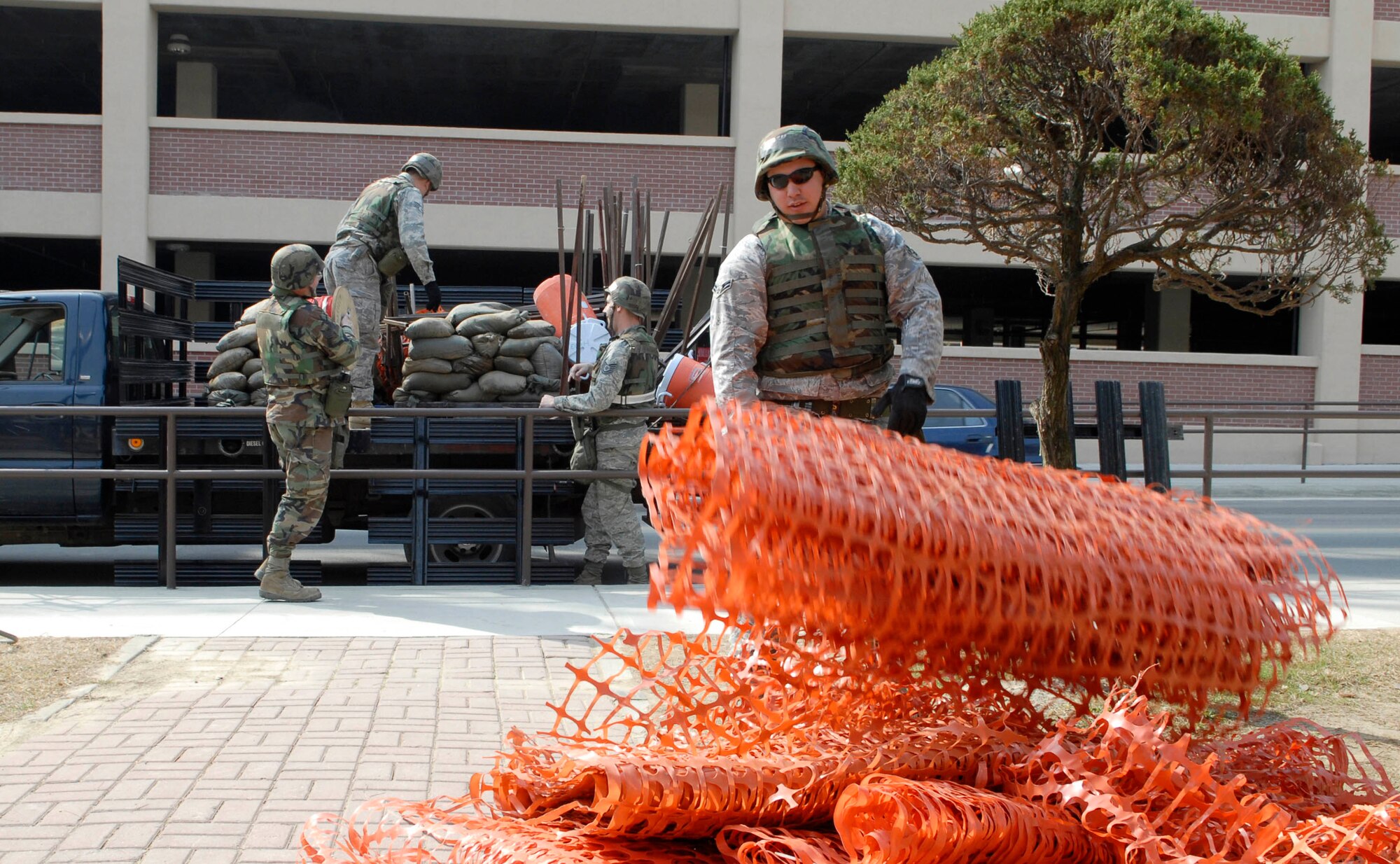Airmen from the 51st Fighter Wing unload supplies outside of the Osan High School March 29, in preparation for a Noncombatant Evacuation Exercise held at Osan AB, Republic of Korea. A NEO exercise tests a bases capability to evacuate noncombatants and nonessential personnel from a location in a host foreign nation to a safe haven. The NEO was part of a pre-scheduled exercise to prepare for the Operational Readiness Inspection the 51st Fighter Wing will undergo in April. (U.S. Air Force Photo/Staff Sgt. Brian Ferguson)
