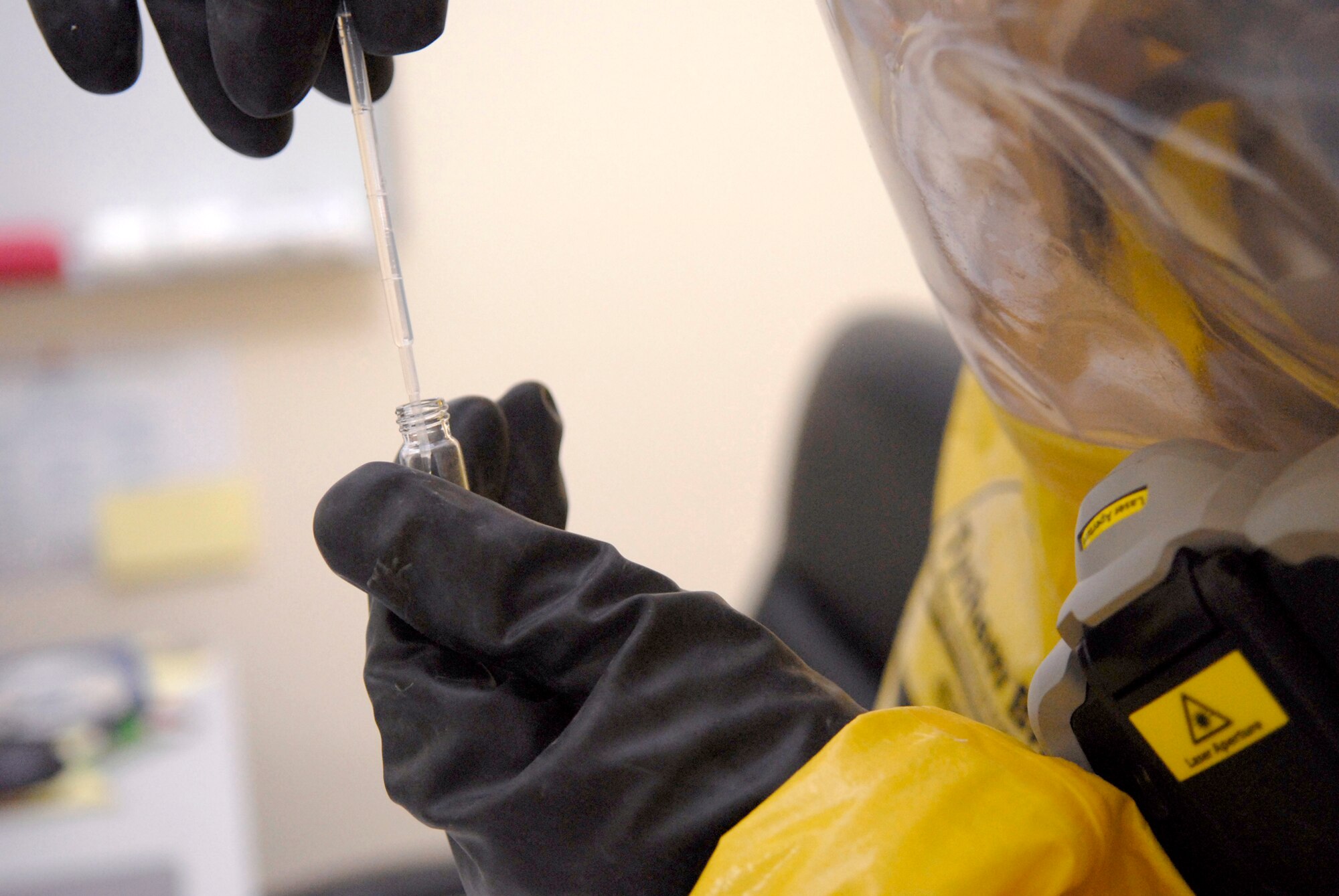 Staff Sgt. Trevor Fettig, a 379th Civil Engineer Squadron Emergency Management Journeyman, draws a found liquid sample for contamination analysis during a unit exercise, Mar. 27, 2009, at an undisclosed location in Southwest Asia.  Sergeant Fettig is labeled the 'dirty man' for handling the contaminated items during the check to help prevent cross contamination with other team members.  Sergeant Fettig hails from Lompoc, Calif. and is deployed from Travis Air Force Base, Calif. in support of Operations Iraqi and Enduring Freedom and Combined Joint Task Force - Horn of Africa.  (U.S. Air Force photo/Senior Airman Andrew Satran/released)