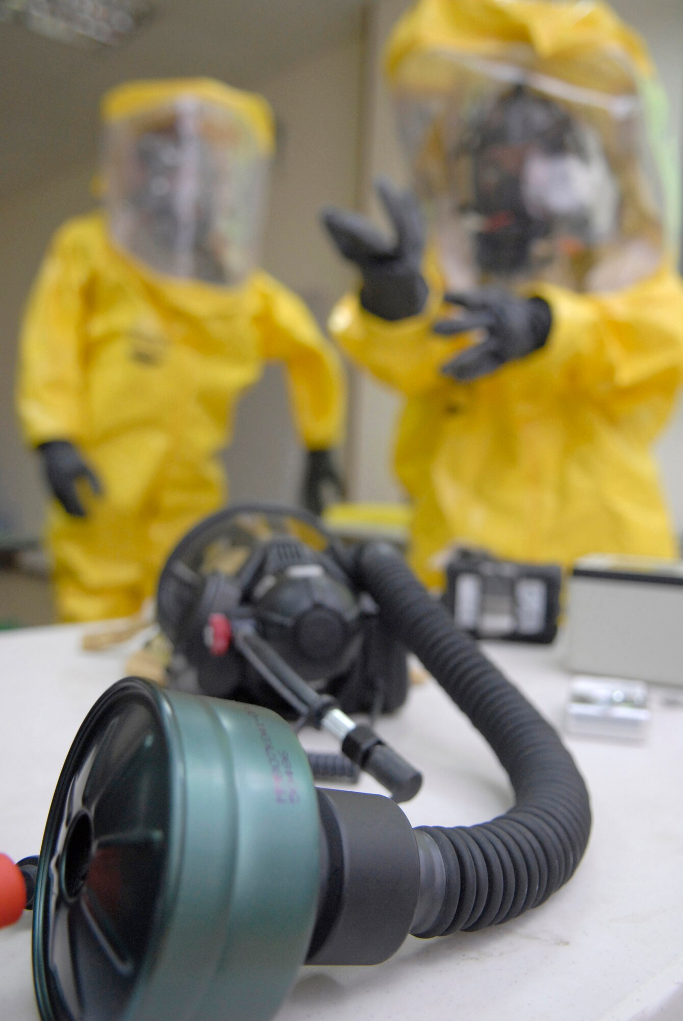 Staff Sgt. Trevor Fettig and Senior Airman Carrie Gay, 379th Expeditionary Civil Engineer Squadron Readiness and Emergency Management Journeymen, wear protective Ty Chem suits during a unit mission readiness exercise, Mar. 27, 2009, at an undisclosed location in Southwest Asia.  The Readiness and Emergency Management team uses a variety of specialized equipment when working with unknown and hazardous materials.  Sergeant Fettig hails from Lompoc, Calif. and is deployed from Travis Air Force Base, Calif.  Airman Gay hails from Sacramento, Calif. and is deployed from McConnell Air Force Base, Kan.  Both are deployed in support of Operation Iraqi and Enduring Freedom and Combined Joint Task Force - Horn of Africa.  (U.S. Air Force photo/Senior Airman Andrew Satran/released)   