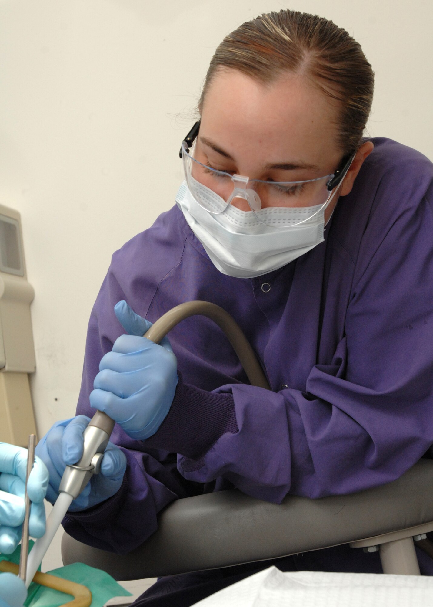 SPANGDAHLEM AIR BASE, Germany -- Airman 1st Class Danielle Kinder, 52nd Dental Squadron, assists a dentist with a filling March 27, 2009. She is a dental assistant from Findlay, Ohio. Airman Kinder is the 52nd Fighter Wing's Top Saber Performer for the week of April 3-9. (U.S. Air Force photo by Senior Airman Jenifer H. Calhoun)