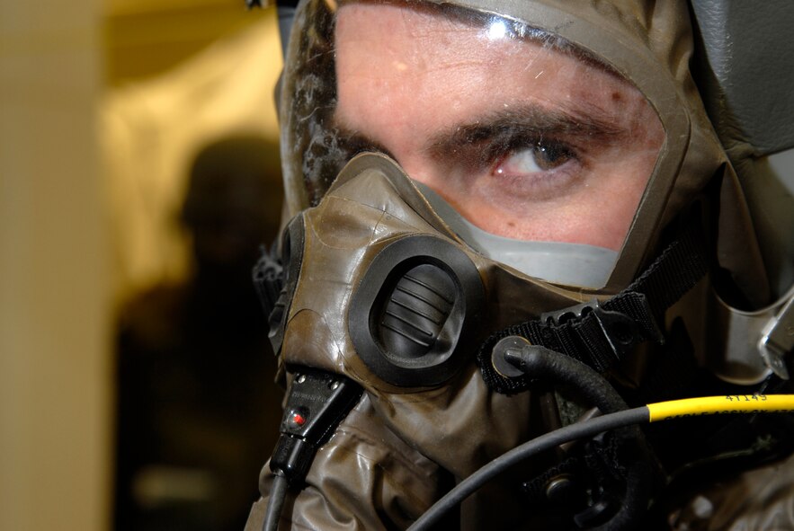 First Lt. Brad Zimmerman, 80th Fighter Squadron, waits while members of the Aircrew Flight Equipment decontamination team removes equipment from him, March 30, 2009 at Kunsan Air Base, Republic of Korea. The Airmen are currently participating in Beverly Bulldog 09-02 , the last Peninsula-wide Operational Readiness Exercise before the 8th Fighter Wing's Operational Readiness Inspection. (U.S. Air Force Photo by Staff Sgt. Jason Colbert)
