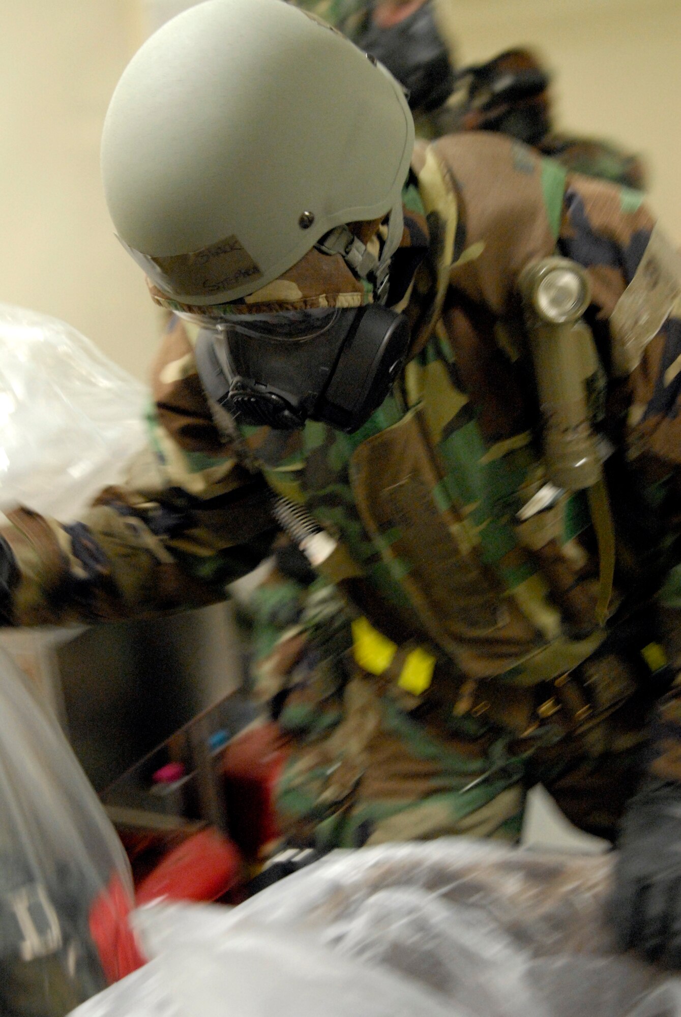 Senior Airman Stephen Slack, 35th Fighter Squadron Aircrew flight equipment technician, disposes of a piece of contaminated aircrew flight equipment at Kunsan Air Base, Republic of Korea, March 30, 2009. The Airmen are currently participating in Beverly Bulldog 09-02, the last Peninsula-wide Operational Readiness Exercise before the 8th Fighter Wing's Operational Readiness Inspection. (U.S. Air Force Photo by Staff Sgt. Jason Colbert)
