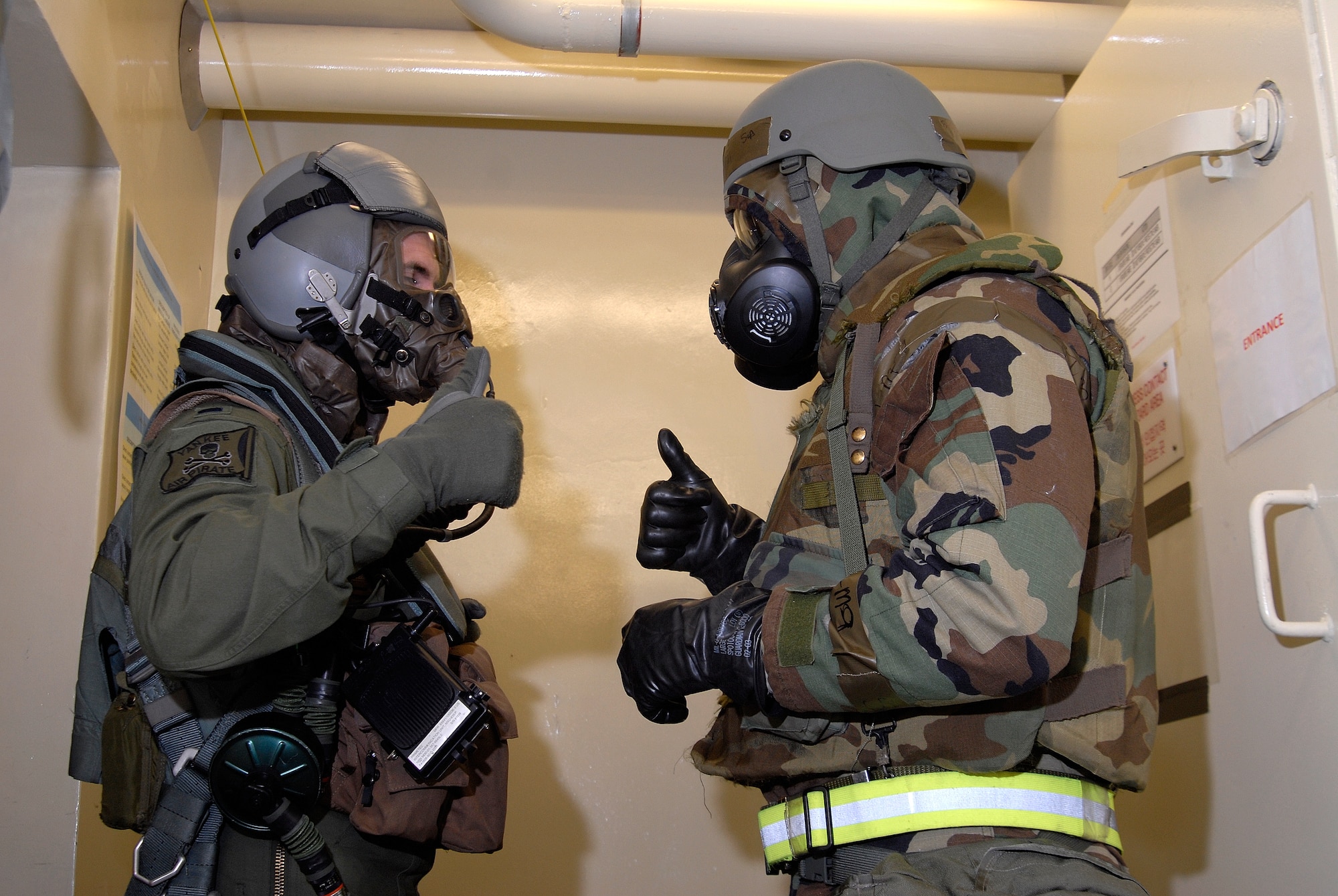 Senior Airman Ramon Hill (Right), 35th Fighter Squadron aircrew flight equipment technician, gets a 'thumbs-up' from 1st Lt. Brad Zimmerman, 80th Fighter Squadron, before beginning a decontamination process at Kunsan Air Base, Republic of Korea, March 30, 2009. The Airmen are currently participating in Beverly Bulldog 09-02, the last Peninsula-wide Operational Readiness Exercise before the 8th Fighter Wing's Operational Readiness Inspection. (U.S. Air Force Photo by Staff Sgt. Jason Colbert)
