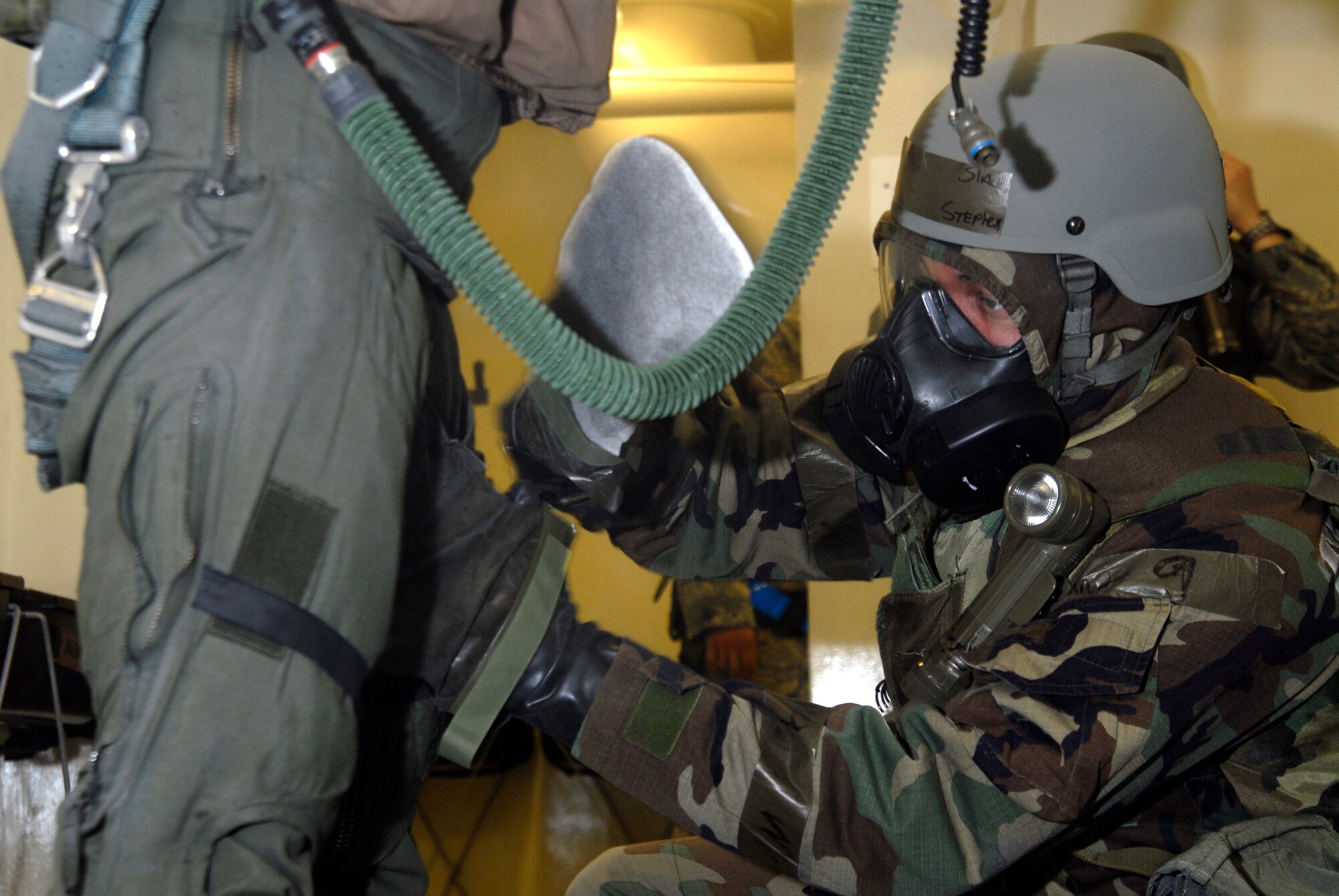 Senior Airman Stephen Slack, 35th Fighter Squadron aircrew flight equipment technician, decontaminates 1st Lt. Brad Zimmerman, 80th Fighter Squadron, at Kunsan Air Base, Republic of Korea, March 30, 2009. The Airmen are currently participating in Beverly Bulldog 09-02, the last Peninsula-wide Operational Readiness Exercise before the 8th Fighter Wing's Operational Readiness Inspection. (U.S. Air Force Photo by Staff Sgt. Jason Colbert)
