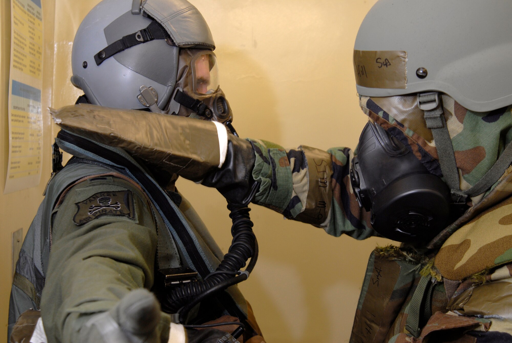 Senior Airman Ramon Hill (right), 35th Fighter Squadron Aircrew flight equipment technician, decontaminates 1st Lt. Brad Zimmerman, 80th Fighter Squadron, at Kunsan Air Base, Republic of Korea, March 30, 2009. The Airmen are currently participating in Beverly Bulldog 09-02, the last Peninsula-wide Operational Readiness Exercise before the 8th Fighter Wing's Operational Readiness Inspection. (U.S. Air Force Photo by Staff Sgt. Jason Colbert)
