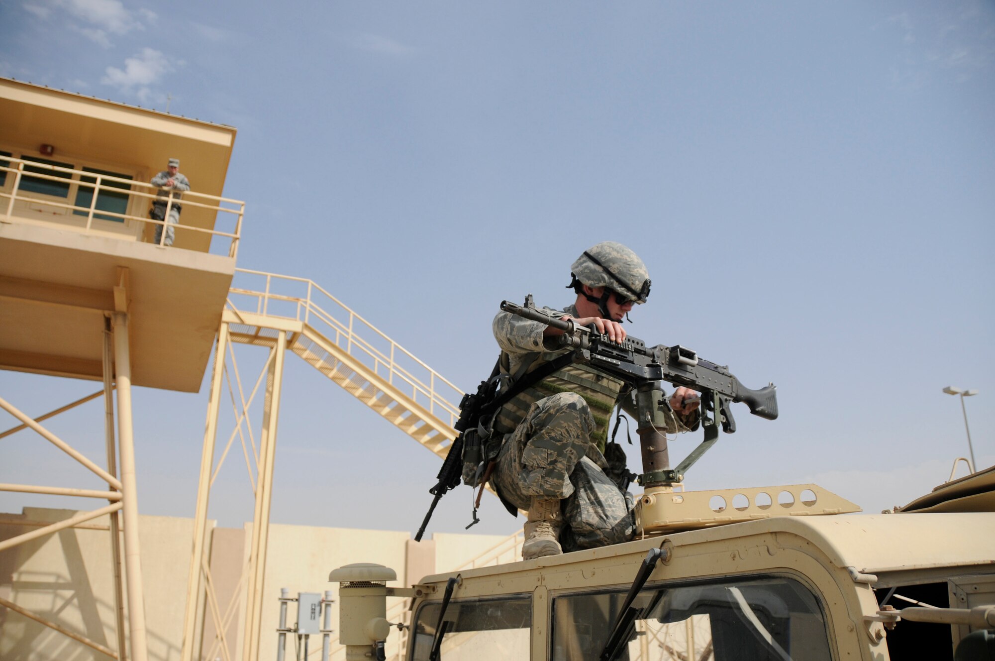 SOUTHWEST ASIA - Airman 1st Class Chadwick Richardson, 380th Expeditionary Security Forces Squadron, assistant gunner mounts an M-240 to the top of a humvee, Mar 21. ESFS personnel perform a number of security duties from manning entry points, guard towers to routine patrols and traffic stops. The ESFS stand as the Air Force's first line of defense. Airman Richardson is deployed from the 28th Security Forces Squadron, Ellsworth AFB, S.D. and hails from Ripley, Maine. (U.S. Air Force photo by Senior Airman Brian J. Ellis) (Released)
