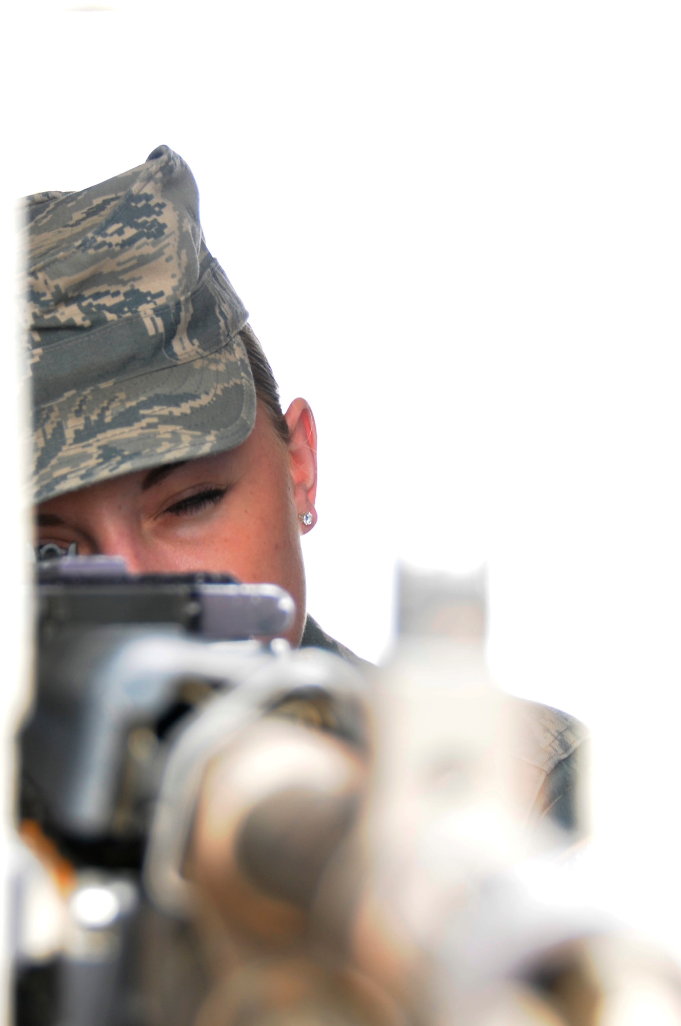 SOUTHWEST ASIA - Senior Airman Christina Best, 380th Expeditionary Security Forces Squadron, response force member mans her post from behind an M-240 in a guard tower, Mar 21. The M-240 gives them a worst case scenario option in the event of a breech to the gate. Airman Best is deployed from the 96th Security Forces Squadron, Eglin AFB, Fla. and hails from Gold Hill, Ore. (U.S. Air Force photo by Senior Airman Brian J. Ellis) (Released)