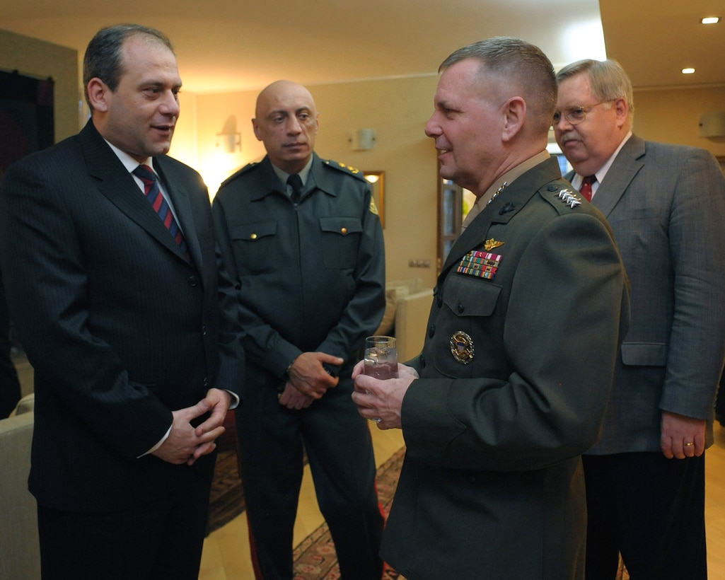 From left, Georgian Minister of Defense David Sikharulidze, Georgian Chief of Defense Maj. Gen. Devi Tchonkotadze and U.S. Ambassador to Georgia John F. Tefft listen to U.S. Marine Gen. James E. Cartwright, vice chairman of the Joint Chiefs of Staff, at a reception in Tbilisi, Georgia, March 30, 2009.