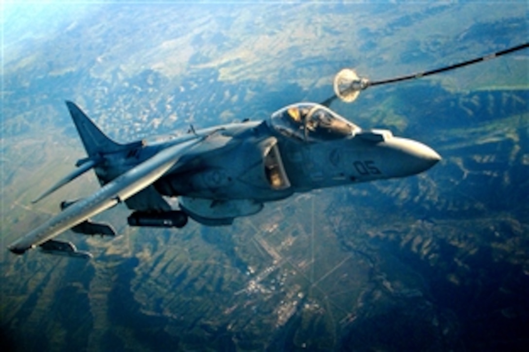 An AV-8B Harrier piloted by U.S. Marine Capt. Daniel S. Fiust takes in fuel while training above Fort Hunter Liggett, Atwater, Calif., March 28, 2009. A KC-130J Hercules turboprop aircraft from San Diego-based Marine Aerial Refueler Transport Squadron 352 circled dozens of times, 22,000 feet above the remote Army post, and refueled the Harrier three times, pumping 15,000 pounds of fuel in total. Fiust is assigned to Marine Attack Squadron 513.