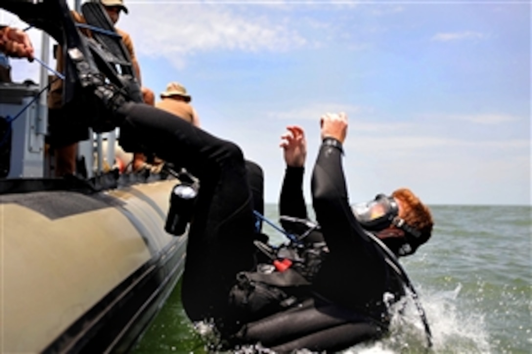 U.S. Navy Petty Officer 2nd Class John Handrahan splashes into Lake Victoria, March 28, 2009, as part of an operation by Combined Joint Task Force-Horn of Africa and the government of Uganda to find and recover the wreckage of the Ilyushin 76 transport plane that crashed near Entebbe, Uganda, March 9, 2009. Handrahan is assigned to Explosive Ordnance Disposal Mobile Unit 8.