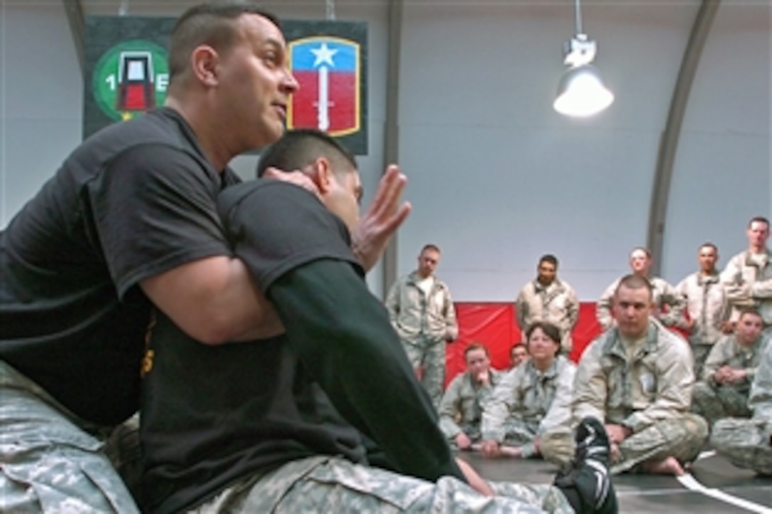 U.S. Army Staff Sgt. Marcos De Jesus demonstrates to soldiers how to employ a single wing rear naked choke during an Army combatives training course on Camp Atterbury, Ind., March 23, 2009. De Jesus is assigned to the 3rd Battalion, 338th Training Support Battalion, 205th Infantry Brigade, First Army Division East; the soldiers are assigned to the 1161st Transportation Company from the Washington Army National Guard.