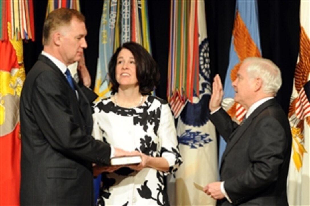 Defense Secretary Robert M. Gates administers the oath of office to Deputy Secretary of Defense William Lynn III as his wife Mary Murphy holds the bible during a welcoming ceremony for Lynn at the Pentagon, March 30, 2009.  Lynn is the 30th deputy secretary of defense.  