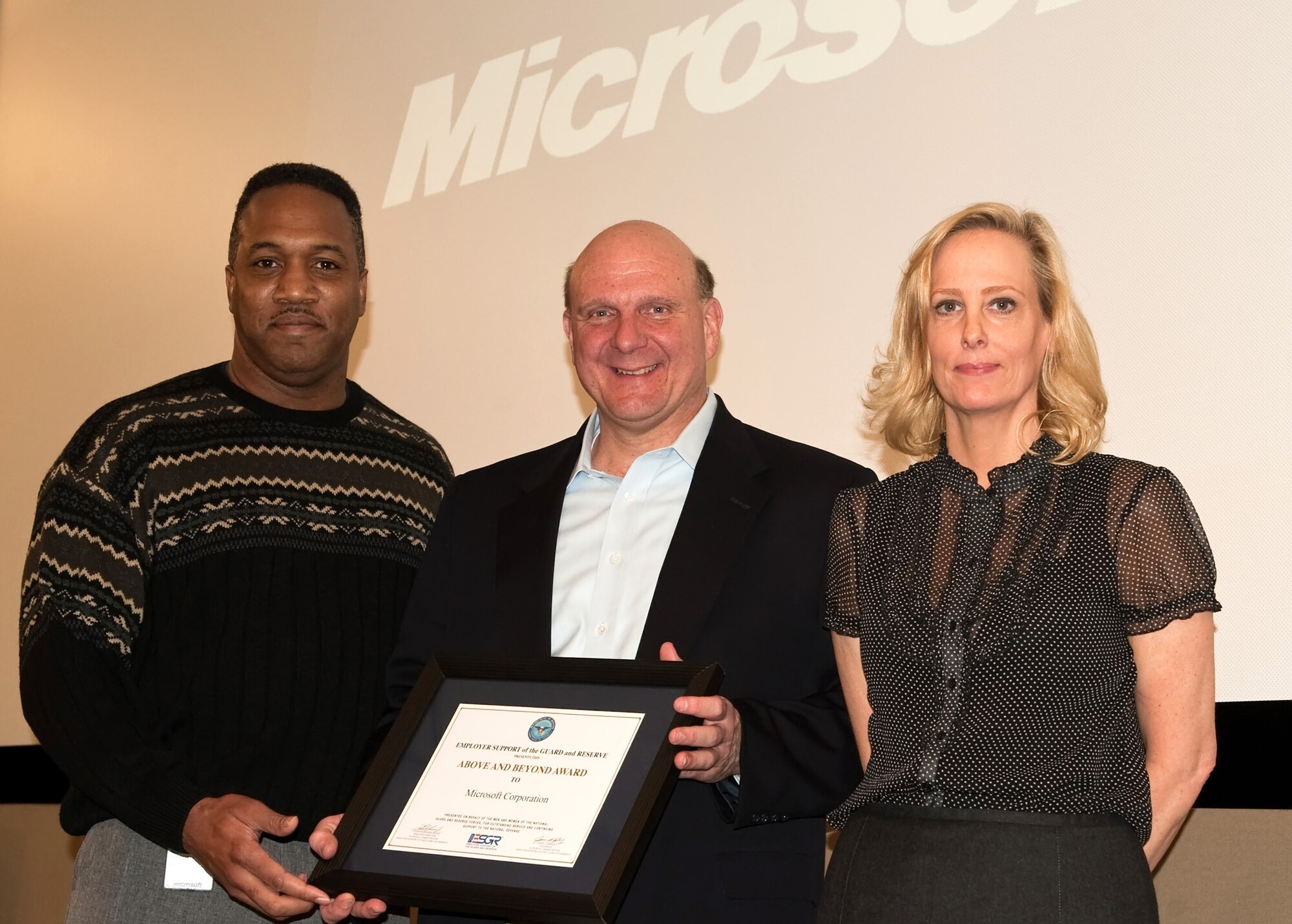 Maj. Stephen Oliver, left, joins Karen Howard in presenting Steve Ballmer, Micorsoft Corporation, with an Employer Support Guard and Reserve "Above and Beyond" award. Mr. Ballmer was recognized for his and Microsoft's outstanding support for Guardsmen and Reservists who work for Microsoft.  The "Above and Beyond" award is presented by state and county ESGR committe to recognize employers who have gone above and beyond the legal requirements in support of their Guard and Reserve employees.  Major Oliver is a member of the 446th Airlift Wing, and Ms. Howard is a volunteer with ESGR. (Courtesy photo/Paul Swortz, Microsoft)