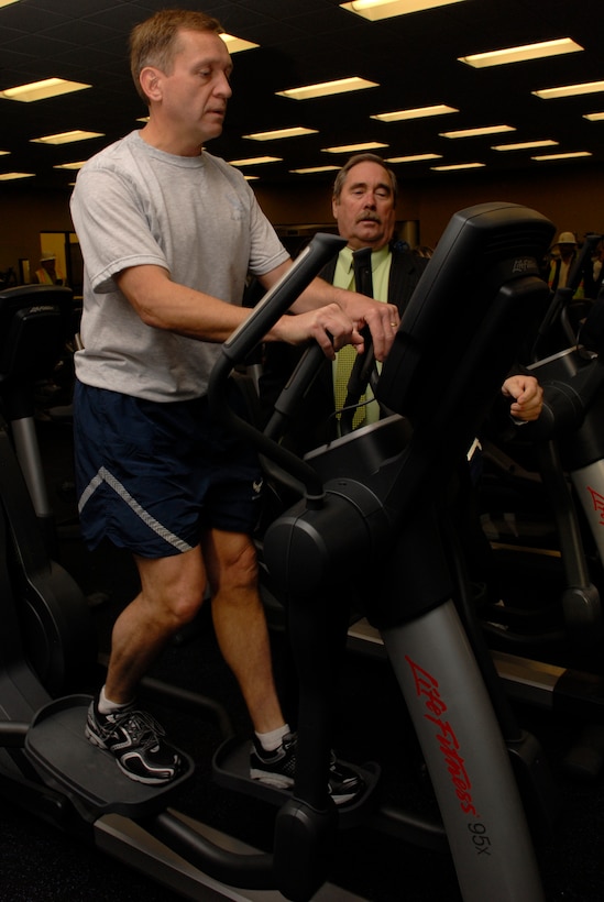 VANDENBERG AIR FORCE BASE, Calif. -- Col. David Buck, the 30th Space Wing commander, and Michael Fitzmaurice, the 30th Force Support Squadron deputy commander, test an elliptical machine after receiving the key to the new Fitness and Sports Center here March 30. The new gym cost approximately $16 million and will feature a smoothie bar, larger locker rooms, massage rooms, three basketball courts, saunas and state of the art exercise equipment. (U.S. Air Force photo/Senior Airman Christian Thomas)