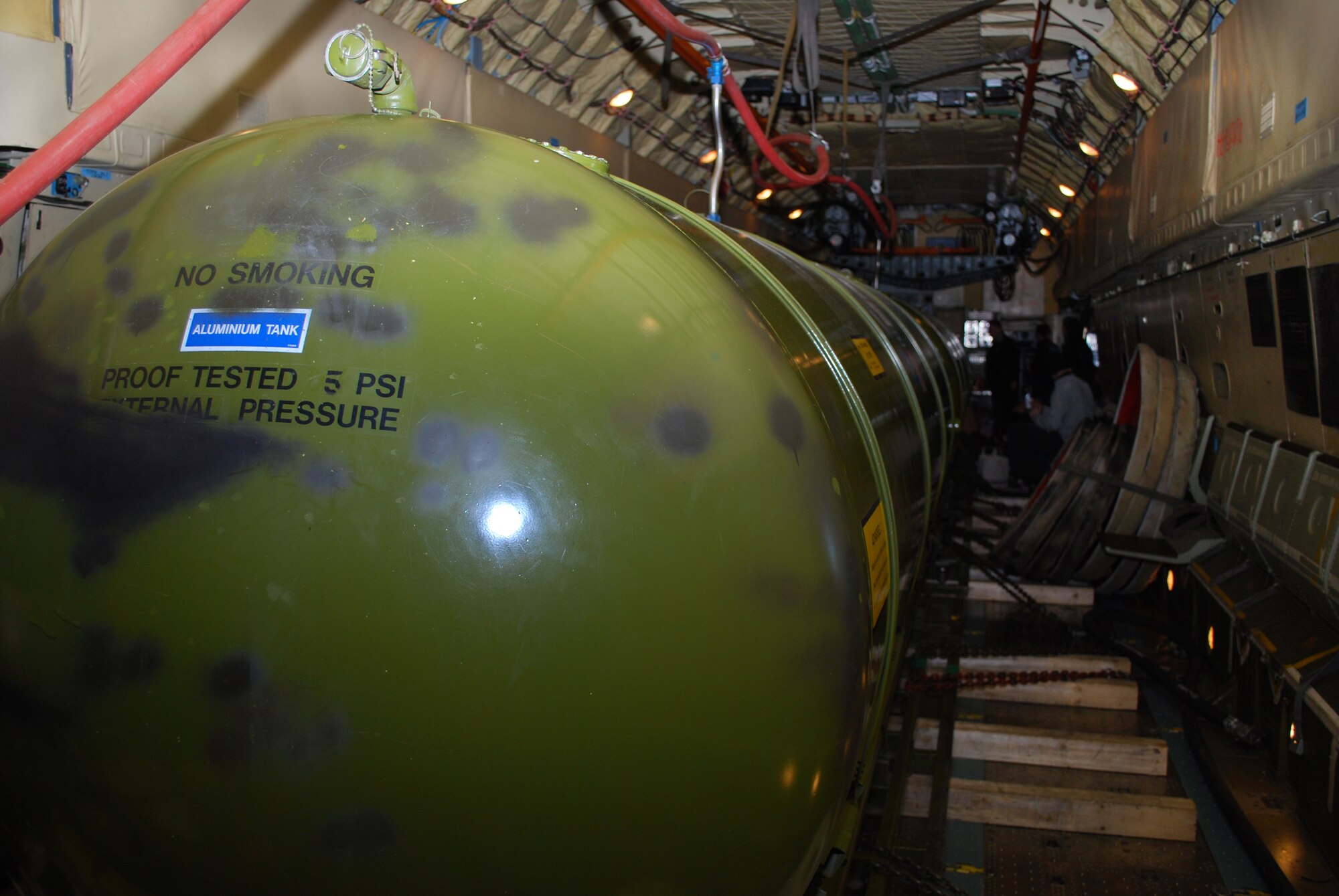 Ukrainians transport fuel March 23 in a Ukrainian IL-76 Ilyushin aircraft to resupply the Danish military outpost, Station Nord, some 600 miles north of Thule Air Base, Greenland, during Operation Brilliant Ice 2009.  The fuel was transported in two large aluminum tanks in the cargo bed and in the wings of the aircraft and required 16 trips to complete the delivery.  (U.S. Air Force photo/1st Lt. Lisa Meiman).