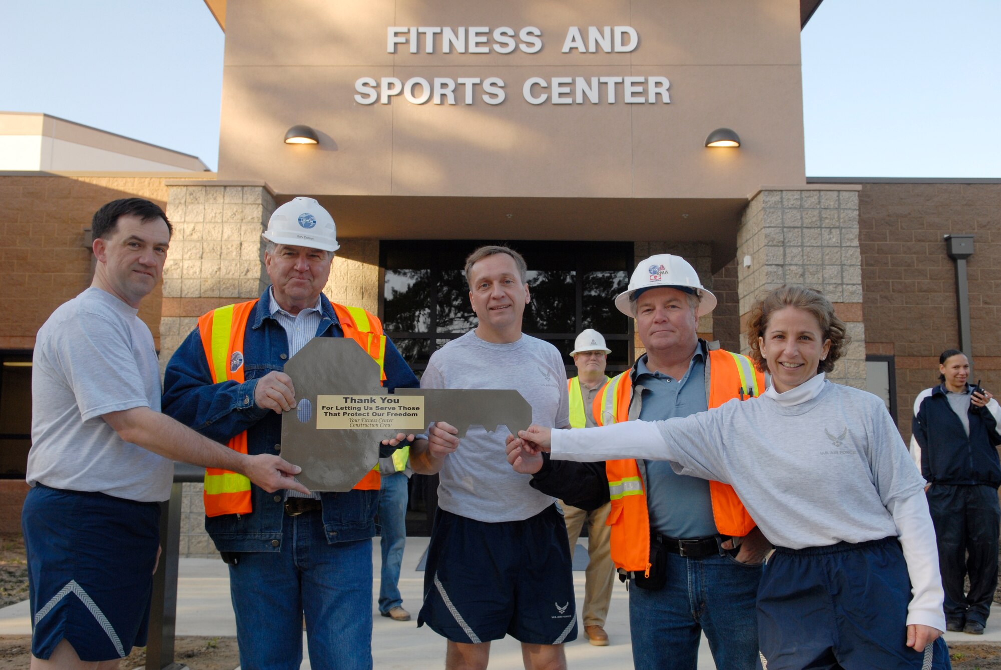 VANDENBERG AIR FORCE BASE, Calif. -- Col. David Buck, the 30th Space Wing commander, along with Col. Richard Wright, the 30th Mission Support Group commander, and Chief Master Sgt. Cari Kent, the 30th Space Wing command chief, receive the key to the new Fitness and Sports Center March 30. The new gym cost approximately $16 million and will feature a smoothie bar, larger locker rooms, massage rooms, three basketball courts, saunas and state of the art exercise equipment. (U.S. Air Force photo/Senior Airman Christian Thomas)