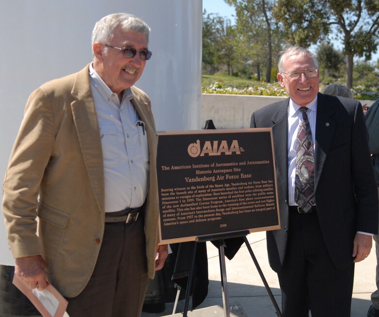 VANDENBERG AIR FORCE BASE, Calif. -- Brig. Gen. (Ret.) Sebastian Coglitore and Chief Master Sgt. (Ret.) Bob Kelchner have a photo taken to commemorate the ceremony in which the American Institute of Aeronautics and Astronautics honored Vandenberg for its contributions to space. General Coglitore was the 30th Space Wing's first commander. (Air Force Photo/Senior Airman Wesley Carter)  