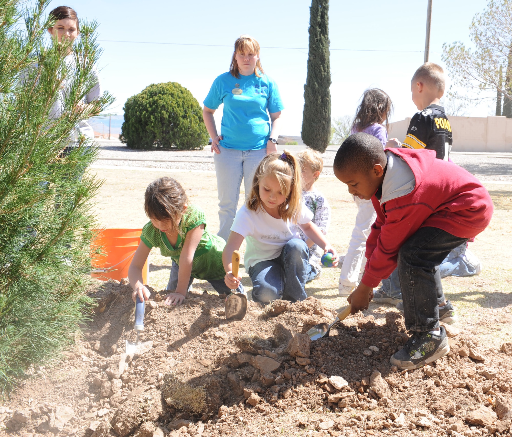 Children from the Career Development Center help plant a tree during the annual Arbor Day Celebration, March 23, at Holloman Air Force Base, N.M. Arbor Day is celebrated in the United States and in many countries around the world. (U.S. Air Force photo/Airman 1st Class Rachel Kocin)