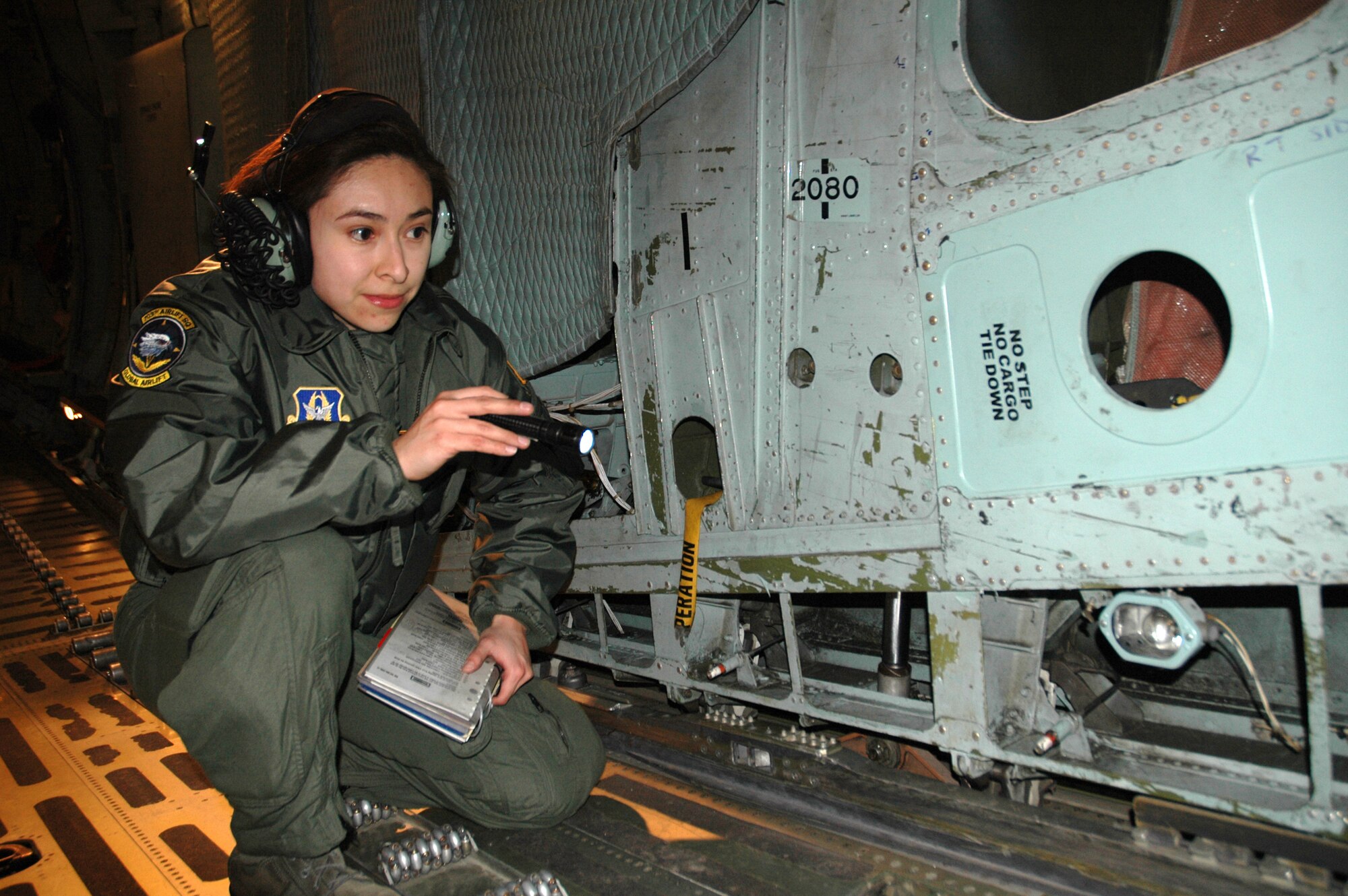 Staff Sgt. Carolina Rodriquez, 709th Airlift Squadron loadmaster, inspects the inside of the C-5 Galaxy during a pre-flight inspection prior to flying a mission in March. Loadmasters are responsible for ensuring cargo is balanced and properly placed and secured on the aircraft for the flight.(U.S. Air Force photo/Senior Airman Deb Robinson)
