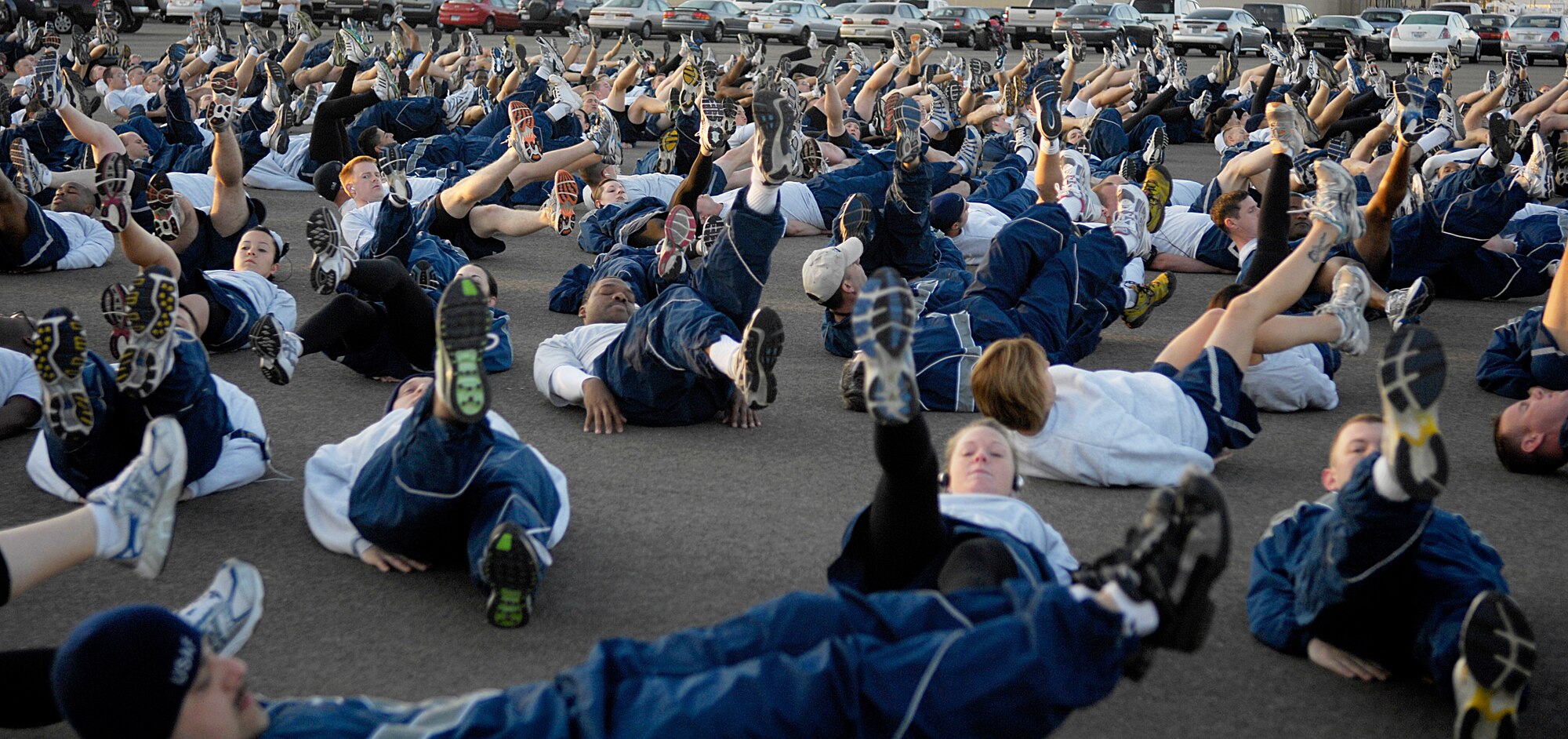 VANDENBERG AIR FORCE BASE, Calif-- Team Vandenberg Airmen warm up with a flutter kick exercise before participating in this month's 30th Space Wing Fit-to-Fight Run at the parade ground here March 30. Every month Airmen from the 30th SW gather for a 3-mile run to promote healthy living, esprit de corps and the fit-to-fight mission of the Air Force. (U.S. Air Force photo/Senior Airman Matthew Plew)