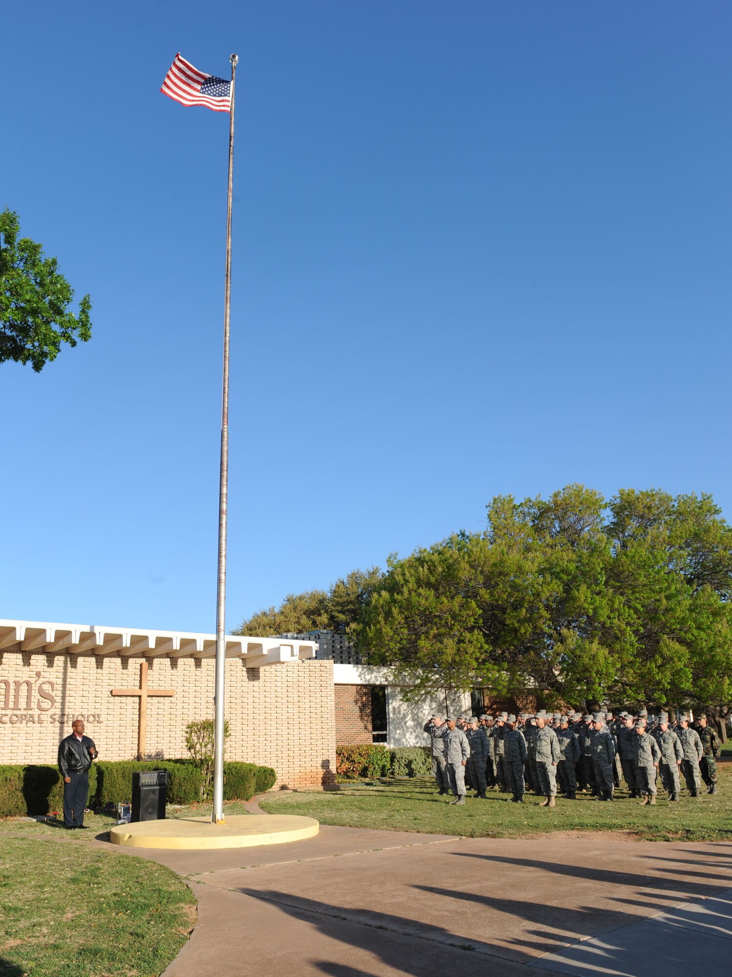 DYESS AIR FORCE BASE, TX-- Airmen from the 7th Logistics Readiness Squadron stand in formation in front of the U.S. flag at Saint John's Elementary here, March 31. The event was put on by the school to salute members of the Armed Forces. (U.S. Air Force photo Senior Airman Domonique Simmons)