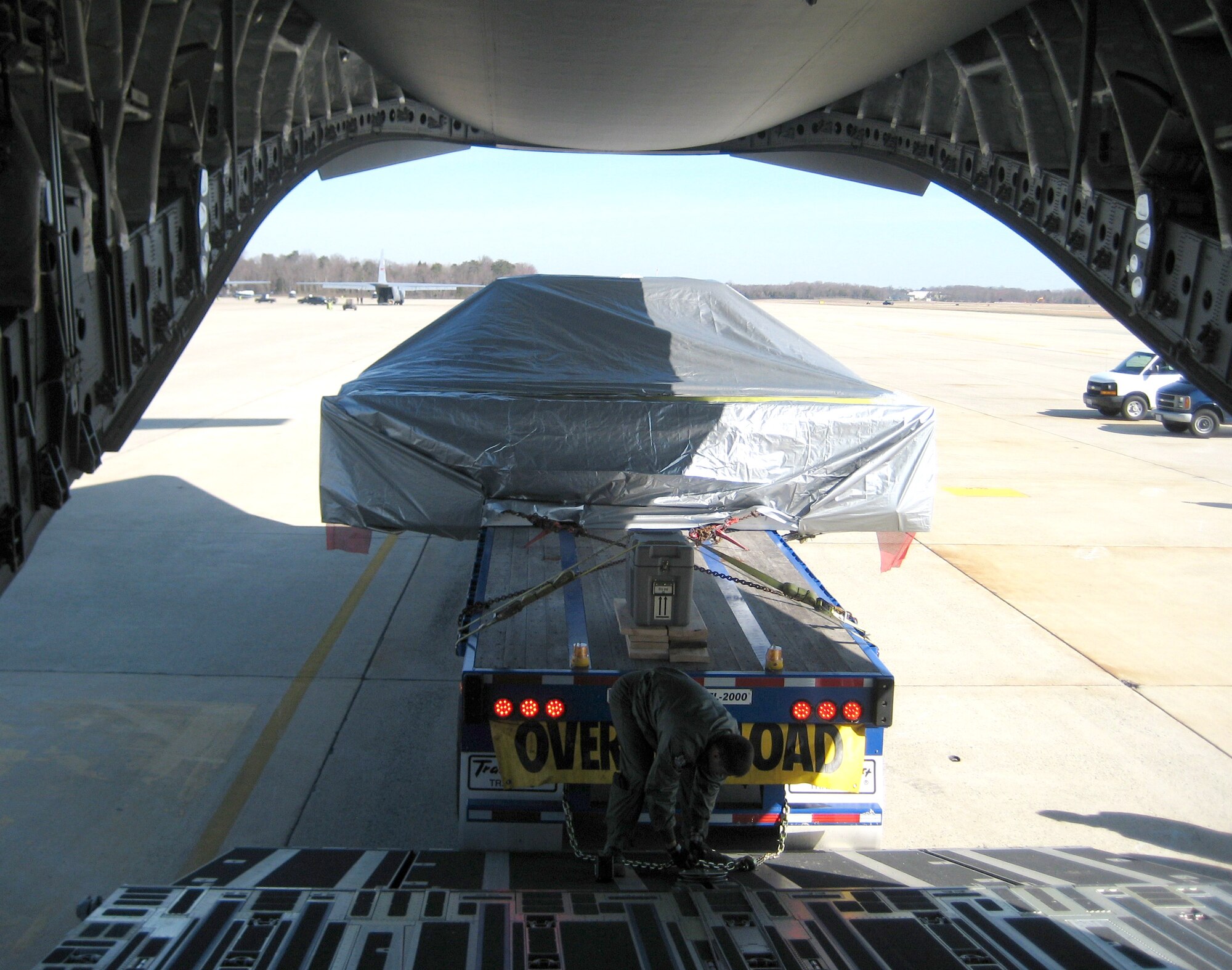 Senior Airman Marc Anderson, a 326th Airlift Squadron loadmaster and reservist at Dover Air Force Base, Del., assists with loading the 17 foot, 6 inch wide and 41,000 pound ExPRESS Logistics Carrier at Andrews Air Force Base, Md., March 21. The ELC took five hours to load in the 18-feet wide bay of the C-17 and was transported to the Kennedy Space Center, Fla., for delivery to the International Space Station this fall. ELCs are unpressurized facilities attached to the ISS that are used for science experiments, storage devices and for electrical power. (U.S. Air Force photo)