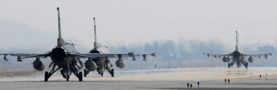 F-16 Falcons taxi down the runway at Osan Air Base, Republic of Korea, during Operations Readiness Exercise Beverly Bulldog 09-02, March 31. The pre-scheduled exercise is designed to help the 51st Fighter Wing prepare for their Operational Readiness Inspection in April. (U.S. Air Force photo/Staff Sgt. Brian Ferguson)