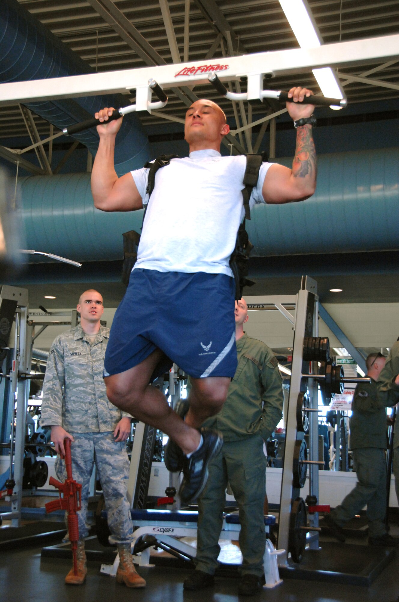 Staff Sgt. Cedric Holliman, member of the 60th Security Forces Squadron, participates in the Travis Special Weapons and Tactics team tryouts March 27.  Sergeant Holliman must be able to do at least two pull ups while carrying a 25-pound backpack in order to qualify for the SWAT team. Each participant trying out for the SWAT team must pass a series of physical endurance tests and be interviewed in order to be eligible for the team. (U.S. Air Force photo/Amanda Lopez)