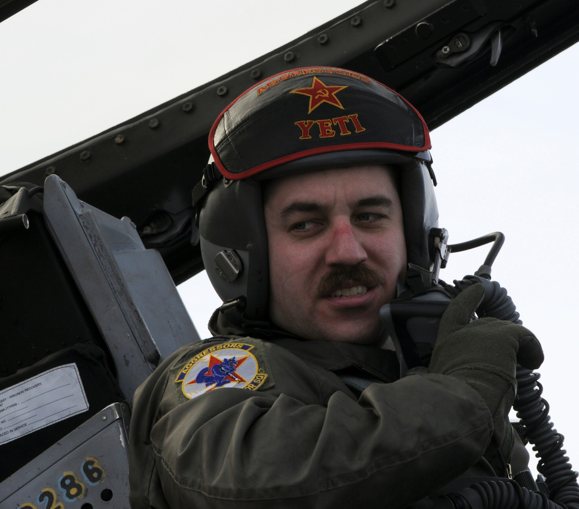 Capt. Christopher Perkins, a pilot with the 18th Aggressor Squadron, informs the crew of the speed an F-16 Fighting Falcon was traveling March 25, 2009, Eielson Air Force Base, Alaska. The F-16 was traveling at a speed of 124 knots when it caught the arresting cable.  It took a total of 853 feet to stop the 19,400-pound aircraft. (U.S. Air Force photo/Airman 1st Class Laura Max)