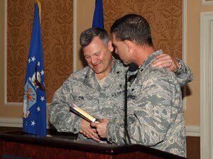 LANGLEY AIR FORCE BASE, Va. -- Brig. Gen. Mark A. Barrett, 1st Fighter Wing commander, presented Tony Dungy's book "Quiet Strength" to Chaplain (Brig. Gen.) David H. Cyr, Air Force Deputy Chief of Chaplains, March 31. The National Prayer Breakfast provides an opportunity for Airmen to reaffirm the moral and spiritual values upon which our nation was founded. (U.S. Air Force photo/Airman 1st Class Gul Crockett)