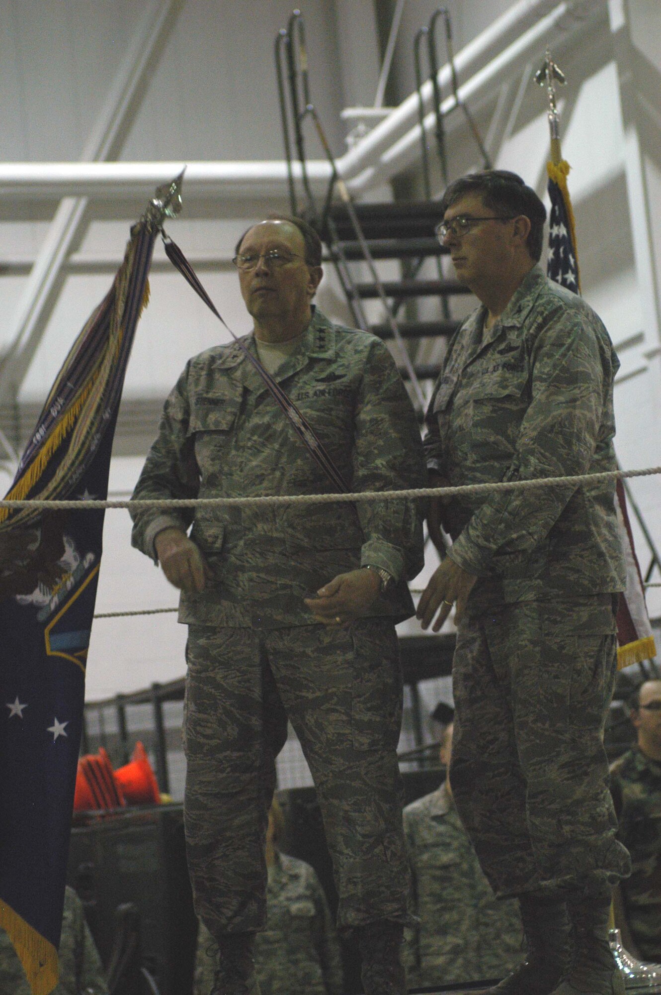 Lt. Gen. Charles E. Stenner Jr., Chief of Air Force Reserve, Headquarters U.S. Air Force, Washington, D.C., and Commander, Air Force Reserve Command, Robins Air Force Base, Ga., along with Col. Gordon H. Elwell, Jr., 911th Airlift Wing commander, attach the Wings' Outstanding Unit Award ribbon on the Wing flag during a commander's call here, March 8, 2009. (photo by Senior Airmen Jamie Perry)