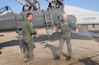 Lt. Col. Chris Causey, 560th Flying Training Squadron, stands at the ready with celebratory champagne as retired Capt. Brian Ratzlaff is sprayed with water following his freedom flight March 26, one of the highlights of the 36th annual Freedom Flyer Reunion. (U.S. Air Force photo by Steve White)