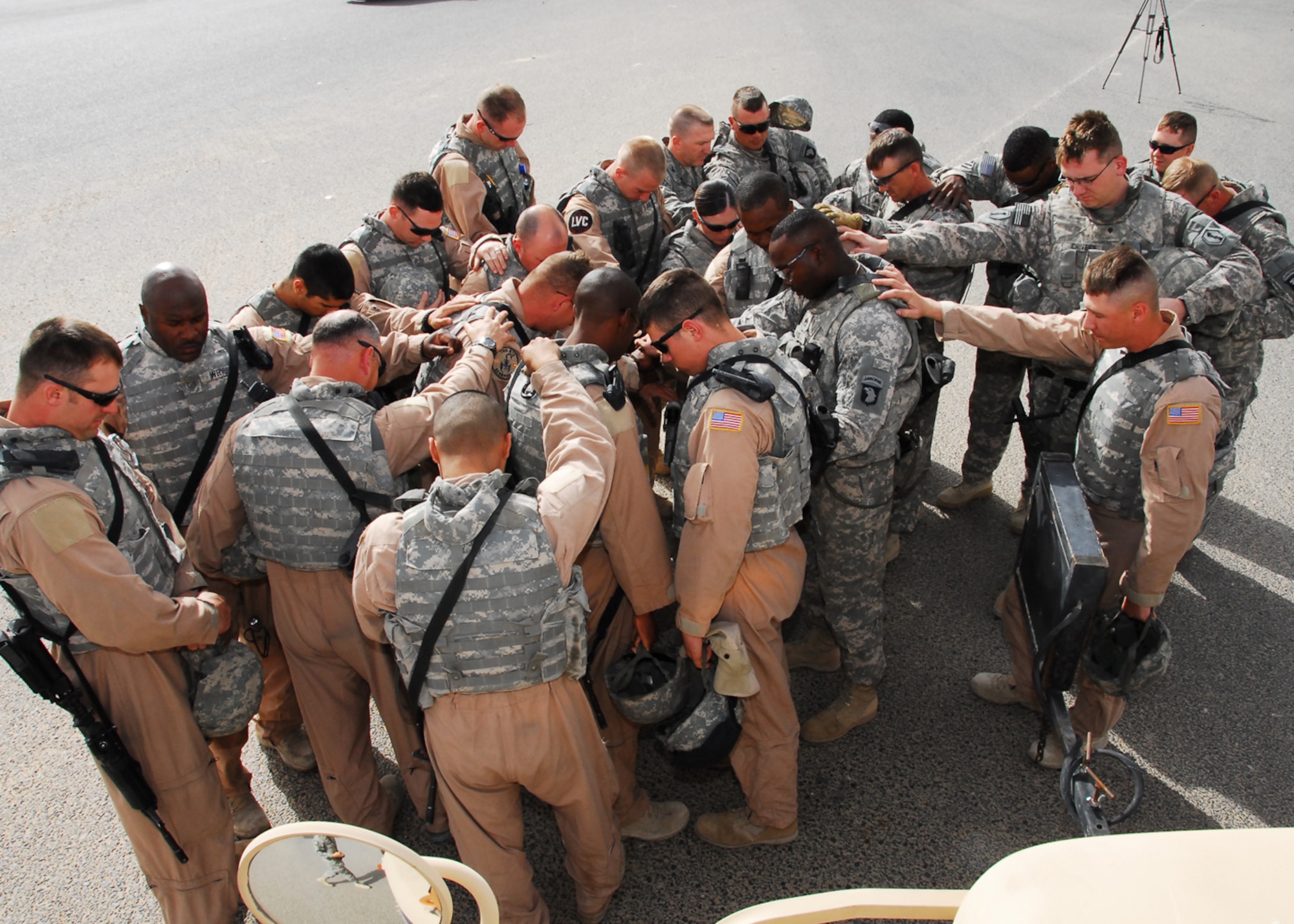 SOUTHWEST ASIA -- Airmen and Soldiers come together for a prayer before mounting up in their vehicles and convoying up and into Iraq at Khabari Crossing, March 26. Although Iraq has become less violent in recent months, ambushes and improvised explosive devices remain a constant threat for the troops. (U.S. Air Force photo/ Senior Airman Courtney Richardson)