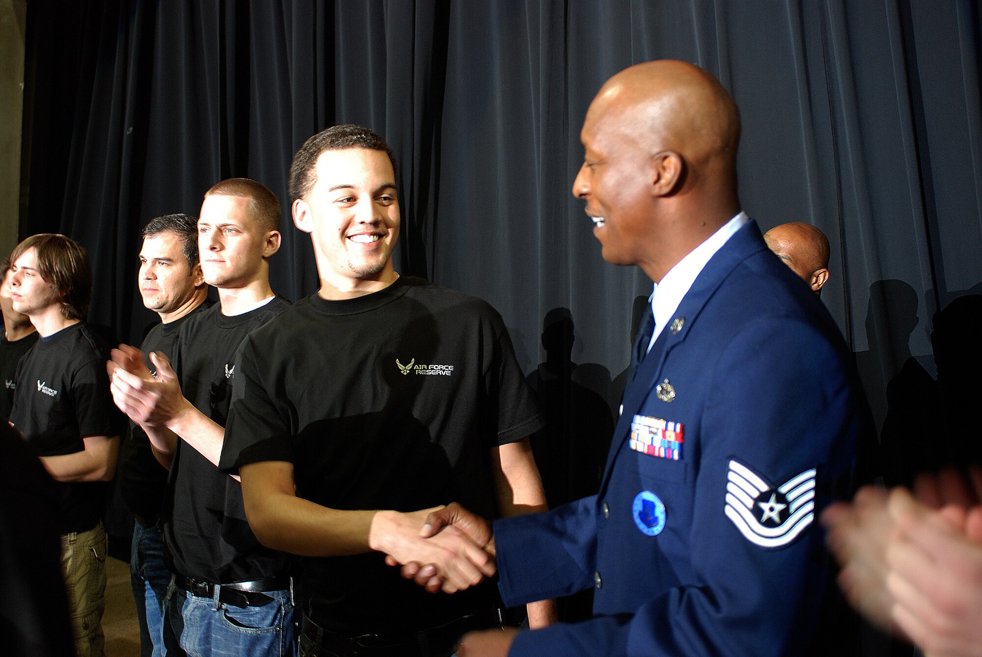 Future Alamo Wing reservists enlist during a mass enlistment ceremony held between the first and second periods of a San Antonio Rampage hockey game. The new members of the U.S. Air Force were welcomed by cheers and applause from the fans nearly filling the stadium. Brig. Gen. John C. Fobian, 433rd Airlift Wing commander, conducted the ceremony and, followed by members of the 433rd Recruiting Squadron, was the first to welcome the Alamo Wing's 15 newest members. The new Recruits will begin Air Force Basic Military Training at various times in the next few months. (U.S. Air Force Photo/Airman Brian McGloin)