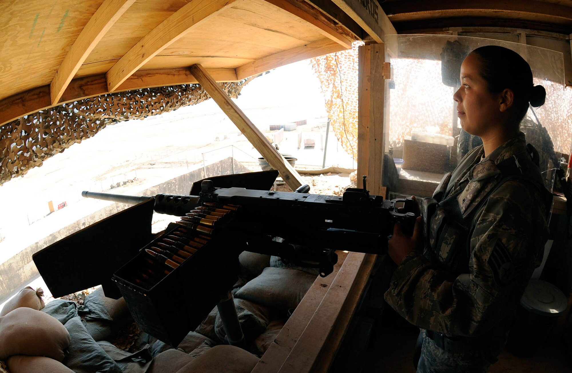 Staff Sgt. Vida Reveles, 447th Expeditionary Security Forces Squadron heavy weapons operator, observes the flight line at Sather Air Base, Iraq while manning a .50 caliber machine gun, March 26. Sgt. Reveles provides show of force for the base making sure that no unauthorized personnel are allowed on the base. Sgt. Reveles is one of a few security forces members qualified on the .50 cal here. Sgt. Reveles is a native of Las Cruces, N.M. and is deployed from the 204th Security Forces Squadron at Biggs Army Airfield, Fort Bliss and El Paso, Texas Air National Guard. (Photo by Senior Airman Jacqueline Romero)