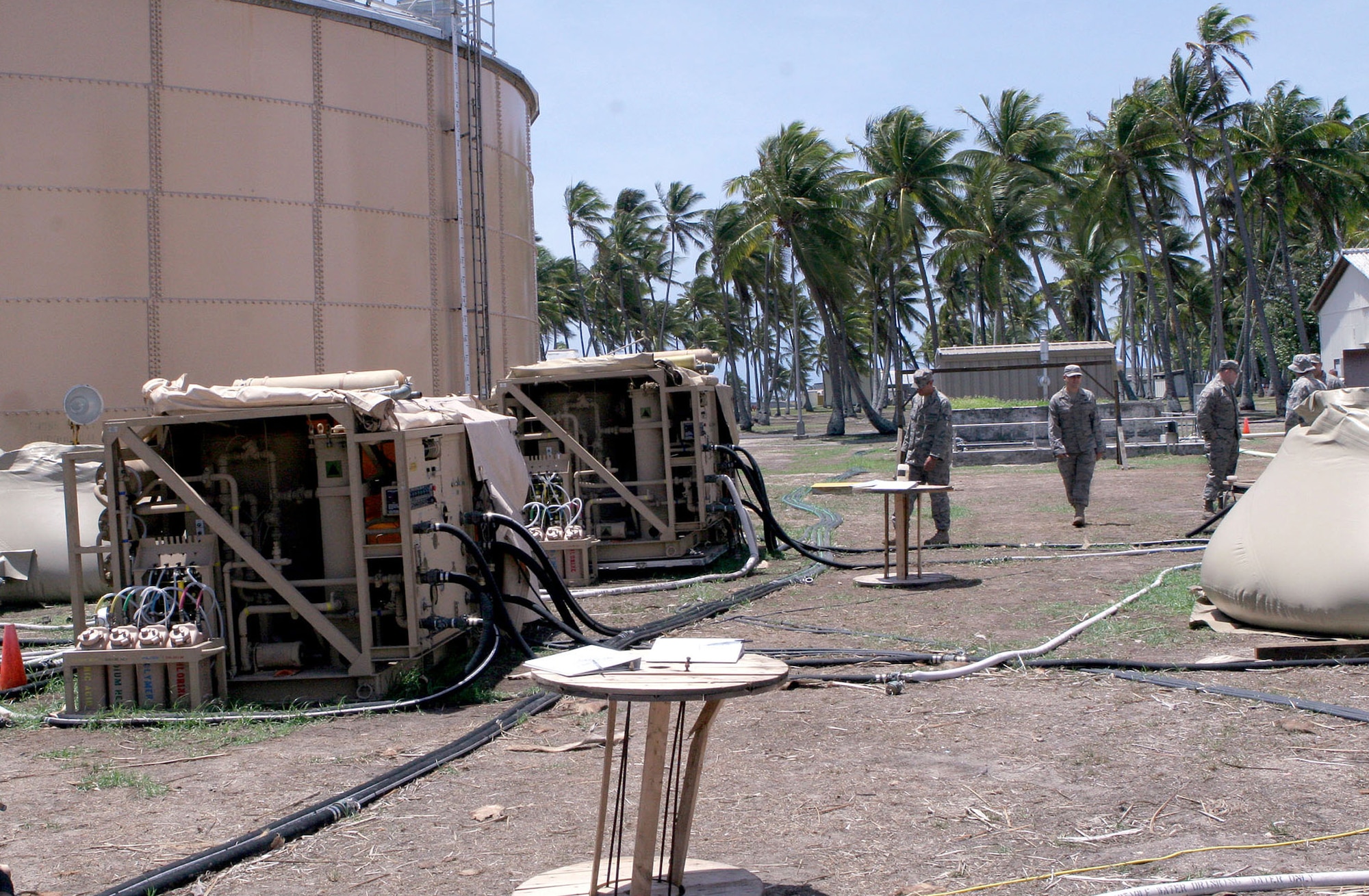 Airmen monitor reverse osmosis machines used for removing particles, sediment and salt from water March 27 at Roi-Namur, an island in the Kwajalein Atoll. The team is deployed to the island to provide clean drinking water to the island's residents. (Courtesy photo) 
