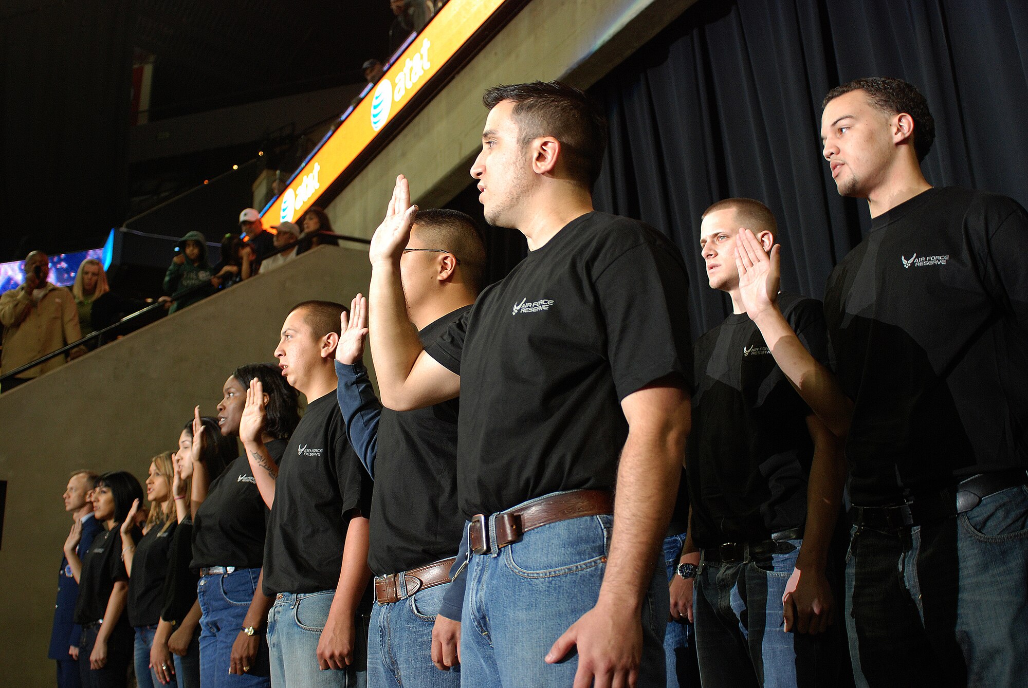 Future Alamo Wing reservists enlist during a mass enlistment ceremony held between the first and second periods of a San Antonio Rampage hockey game. The new members of the U.S. Air Force Reserve were welcomed by cheers and applause from the fans nearly filling the stadium. Brig. Gen. John C. Fobian, 433rd Airlift Wing commander, conducted the ceremony and, followed by members of the 433rd Recruiting Squadron, was the first to welcome the Alamo Wing's 15 newest members. The new Recruits will begin Air Force Basic Military Training, at Lackland, at various times in the next few months. (U.S. Air Force Photo/Airman Brian McGloin)