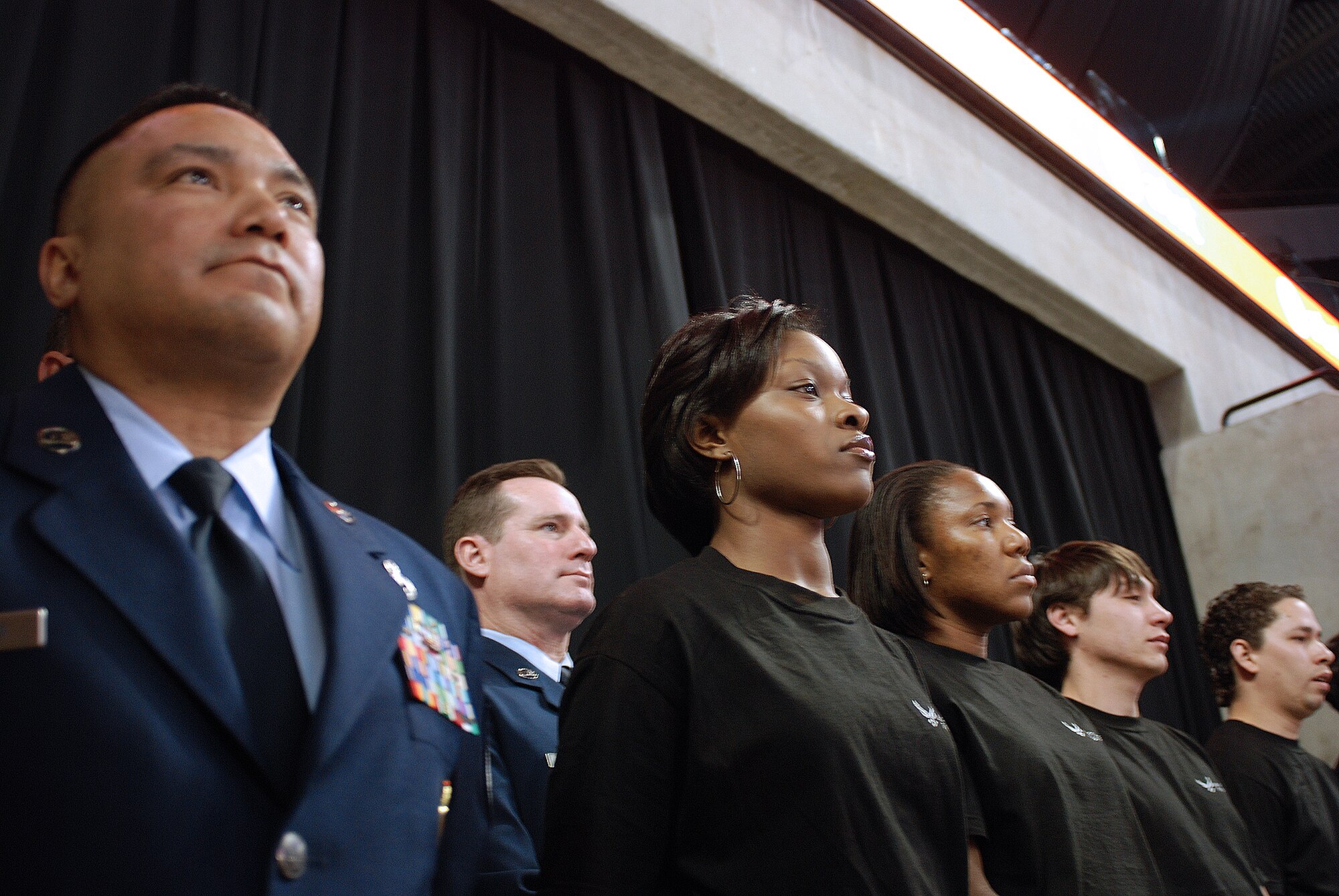 Future Alamo Wing reservists enlist during a mass enlistment ceremony held between the first and second periods of a San Antonio Rampage hockey game. The new members of the U.S. Air Force Reserve were welcomed by cheers and applause from the fans nearly filling the stadium. Brig. Gen. John C. Fobian, 433rd Airlift Wing commander, conducted the ceremony and, followed by members of the 433rd Recruiting Squadron, was the first to welcome the Alamo Wing's 15 newest members. The new Recruits will begin Air Force Basic Military Training at various times in the next few months. (U.S. Air Force Photo/Airman Brian McGloin)