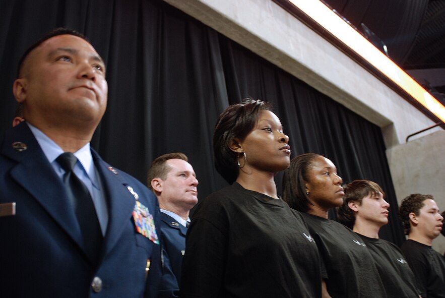 Future Alamo Wing reservists enlist during a mass enlistment ceremony held between the first and second periods of a San Antonio Rampage hockey game. The new members of the U.S. Air Force Reserve were welcomed by cheers and applause from the fans nearly filling the stadium. Brig. Gen. John C. Fobian, 433rd Airlift Wing commander, conducted the ceremony and, followed by members of the 433rd Recruiting Squadron, was the first to welcome the Alamo Wing's 15 newest members. The new Recruits will begin Air Force Basic Military Training at various times in the next few months. (U.S. Air Force Photo/Airman Brian McGloin)