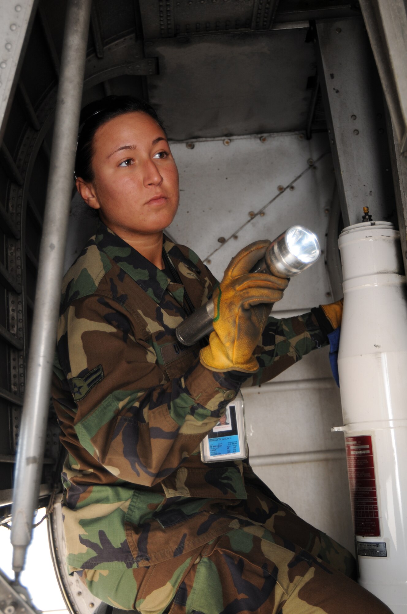A1C Jackie Desmond, a crew chief with the Maintenance Squadron here, performs a pre-flight inspection in the wheel well of a C-130. Routine inspections help ensure that the Youngstown Air Reserve Station's C-130s perform safely and efficiently. 