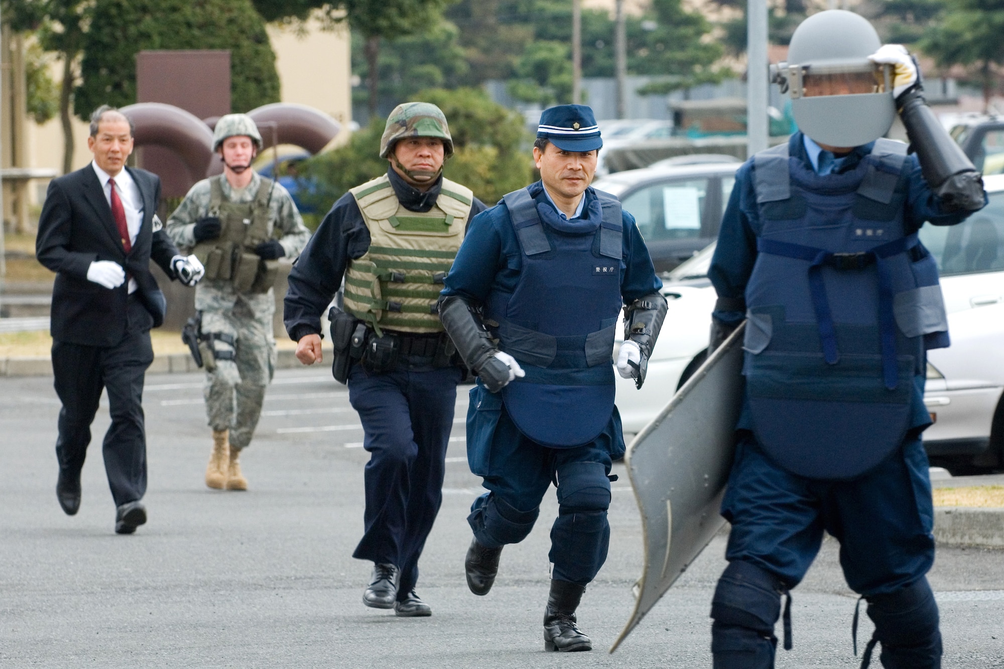 Members of the 374th Security Forces Squadron and the Japanese National Police-Fussa Division respond to a unexploded ordnance "incident" during a joint response training exercise March 27 at Yokota Air Base, Japan. (U.S. Air Force photo/Osakabe Yasuo) 
