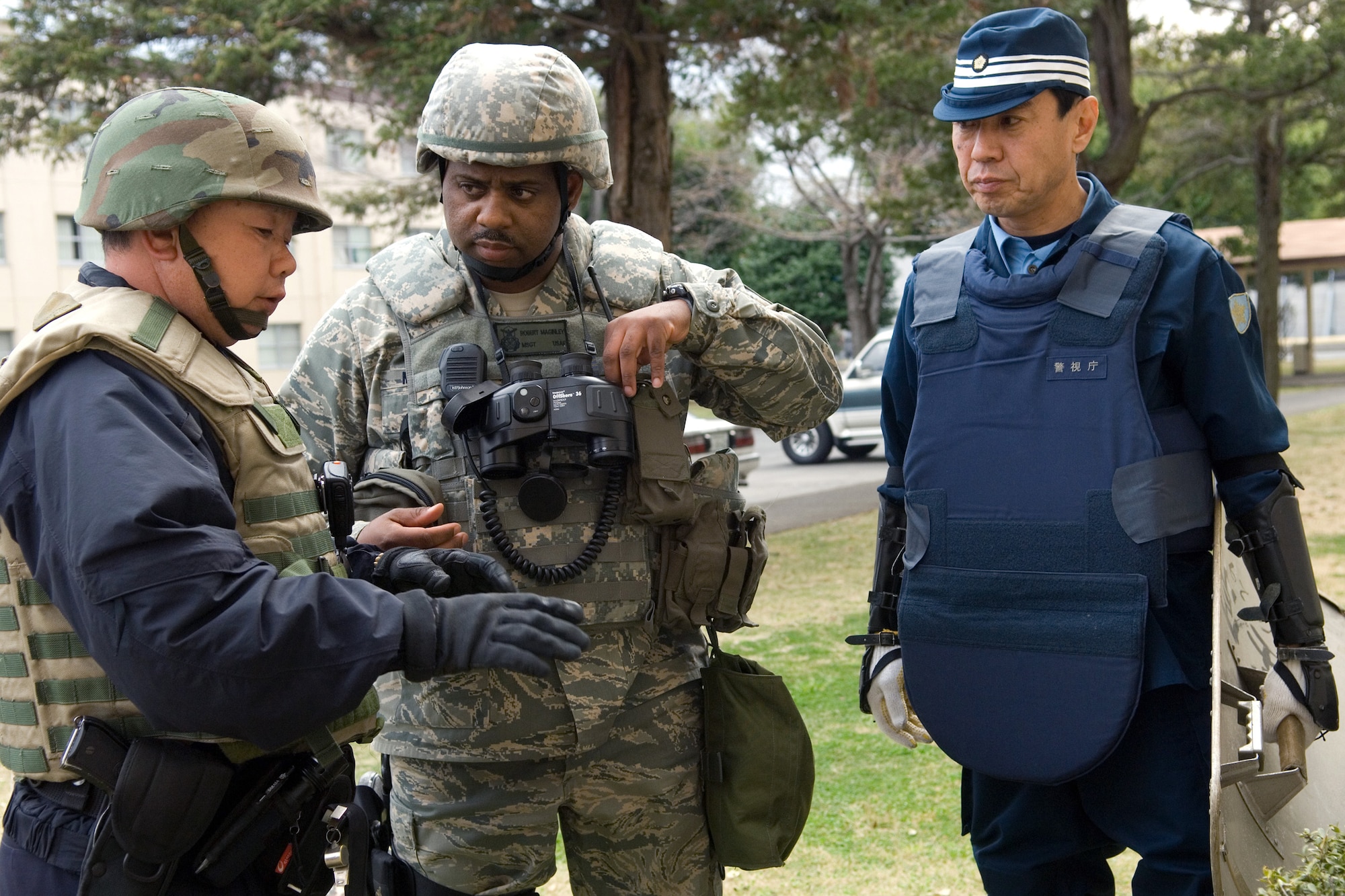 Master. Sgt. Robert Maginley confirms a "projectile" at the landing area and Takeo Yoshimoto translates the situation March 27 at Yokota Air Base, Japan. Sergeant Maginley and Mr. Yoshimoto are assigned to the 374th Security Forces Squadron. (U.S. Air Force photo/Osakabe Yasuo) 
