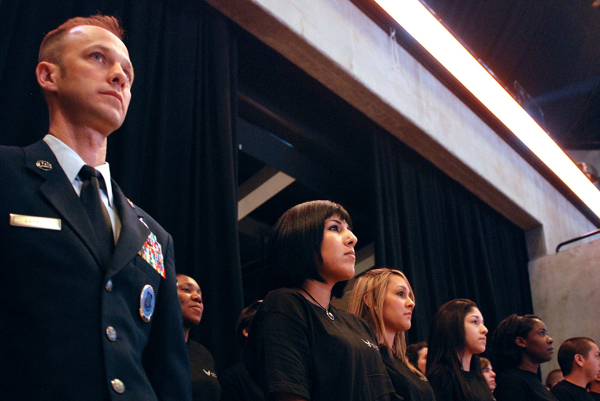 Future Alamo Wing reservists enlist during a mass enlistment ceremony held between the first and second periods of a San Antonio Rampage hockey game. The new members of the U.S. Air Force Reserve were welcomed by cheers and applause from the fans nearly filling the stadium. Brig. Gen. John C. Fobian, 433rd Airlift Wing commander, conducted the ceremony and, followed by members of the 433rd Recruiting Squadron, was the first to welcome the Alamo Wing's 15 newest members. The new Recruits will begin Air Force Basic Military Training at various times in the next few months. (U.S. Air Force Photo/Airman Brian McGloin)