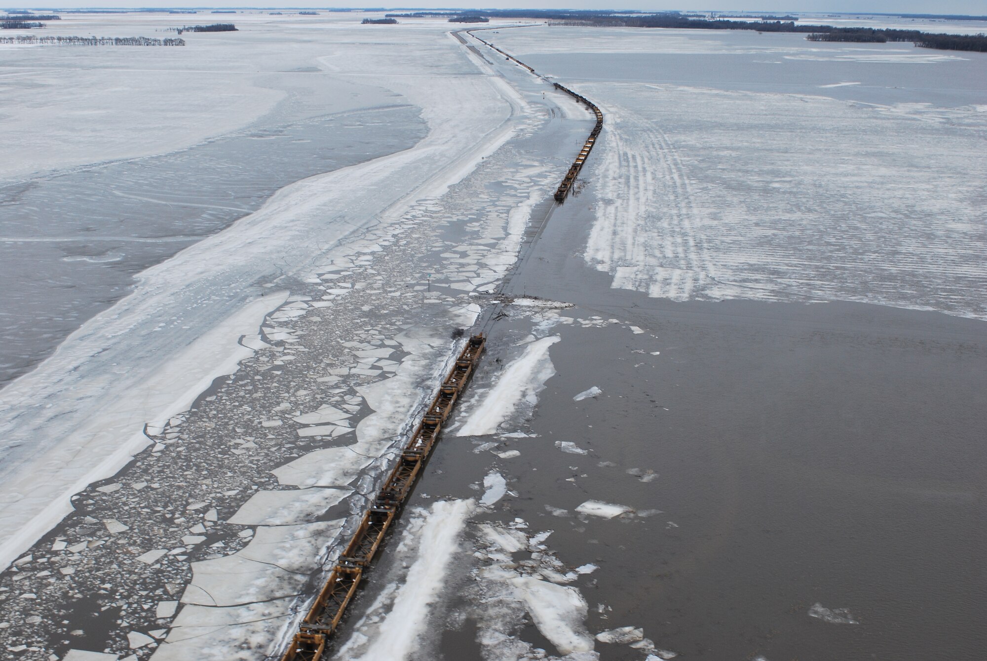FARGO, N.D. -- A UH-1N "Huey" crew from the 54th Helicopter Squadron at Minot Air Force Base, noticed a train frozen in its tracks due to the flooding while performing search and rescue missions on North Dakota’s Red River north of Fargo, N.D. The crew is one of two on alert to provide search and rescue missions in support of flood relief along the Red River. (U.S. Air Force photo by Airman 1st Class Joshua Rosales)