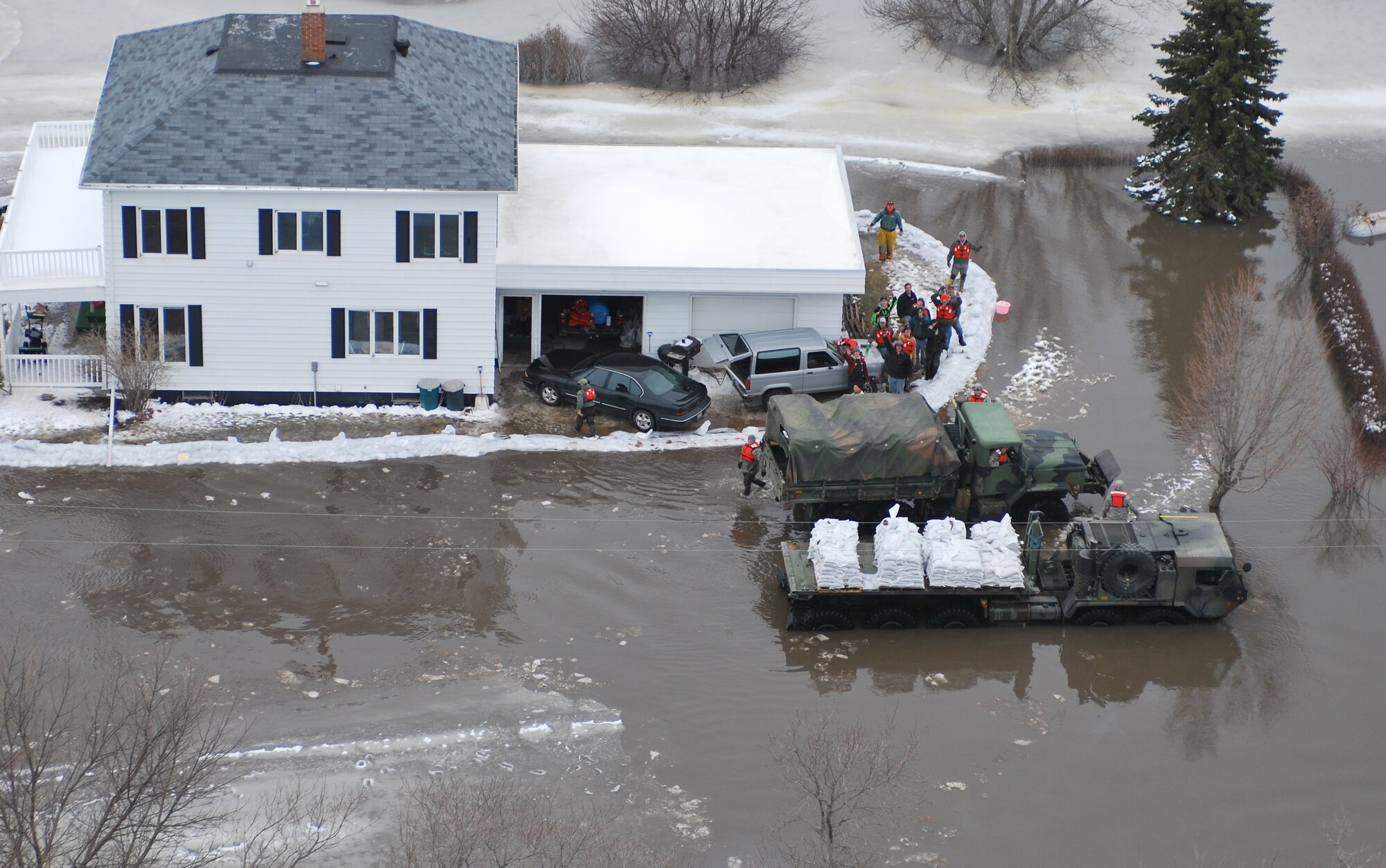 FARGO, N.D. – An over-head photo of one of the many homes hoping to ride out the recent flooding here March 29 along the Red River north of Fargo, N.D. Currently, the 54th Helicopter Squadron from Minot AFB has two UH-1N "Huey" crews at Grand Forks AFB, N.D., on alert to provide search and rescue missions in support of flood relief along the Red River. 2009 was a year that brought progress and a renewed emphasis on safe, secure and reliable nuclear operations. The 91st Missile Wing transitioned to Air Force Global Strike Command with the 5th Bomb Wing scheduled to follow suit in 2010. (U.S. Air Force photo by Airman 1st Class Joshua Rosales)